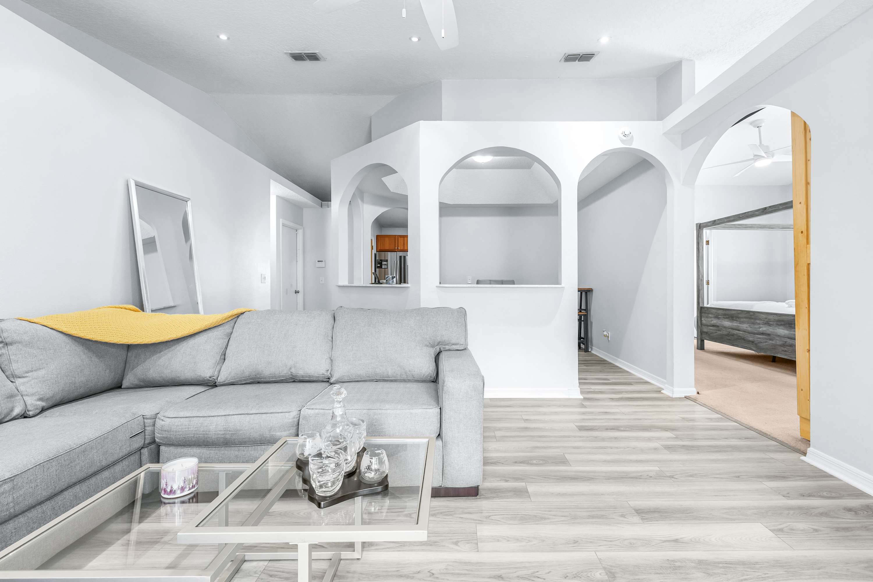Light-filled living space featuring a spacious sectional and Smart TV