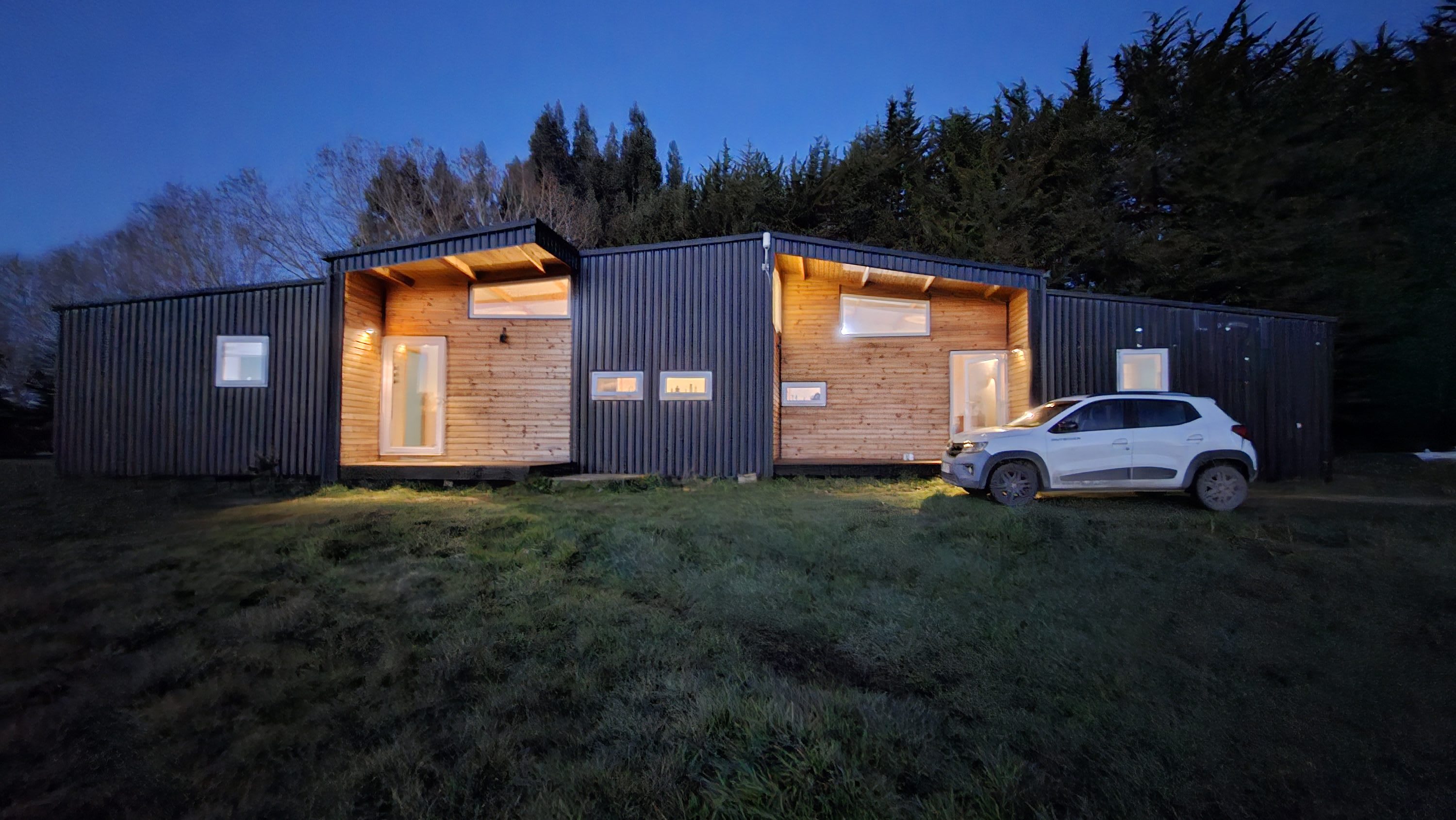 Country house lit up at dusk