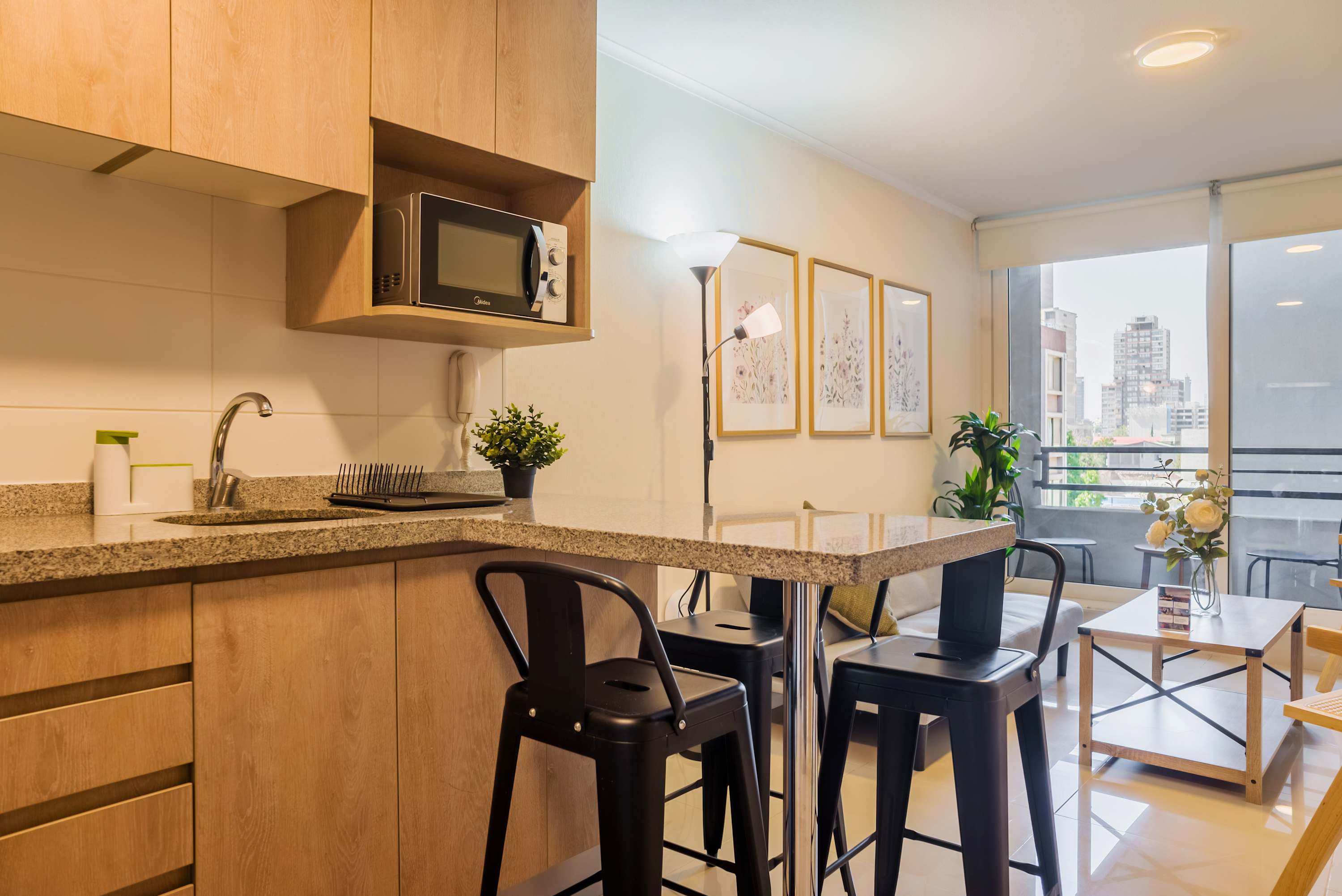 Bright open-plan kitchen with granite counters, a breakfast island for four, and expansive windows overlooking the city.