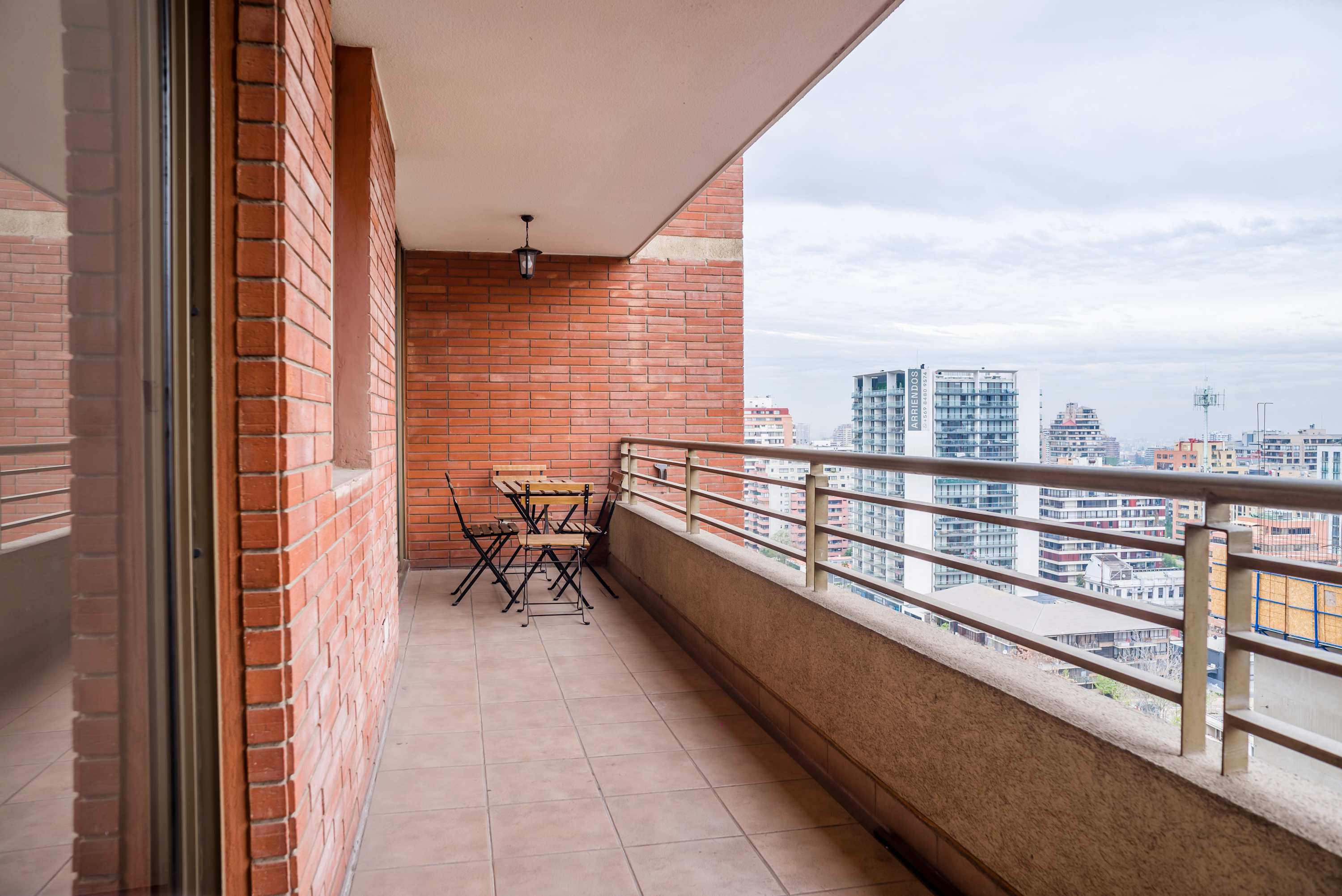 Enjoy city views from the covered balcony, with a four-seat bistro set ready for outdoor coffee or relaxed meals.