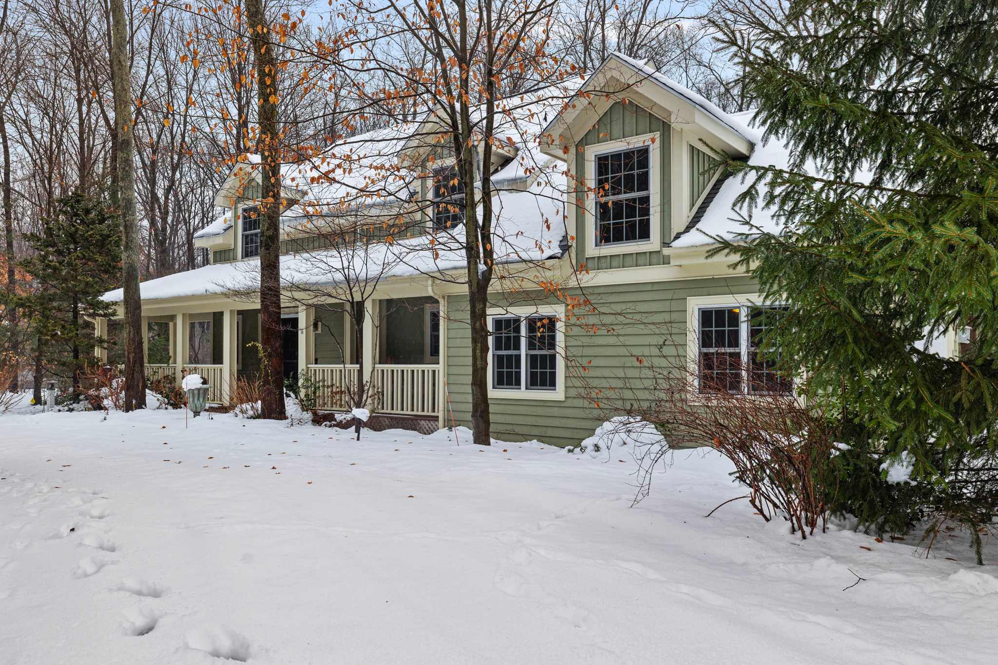 Storybook curb appeal in a peaceful wooded setting.