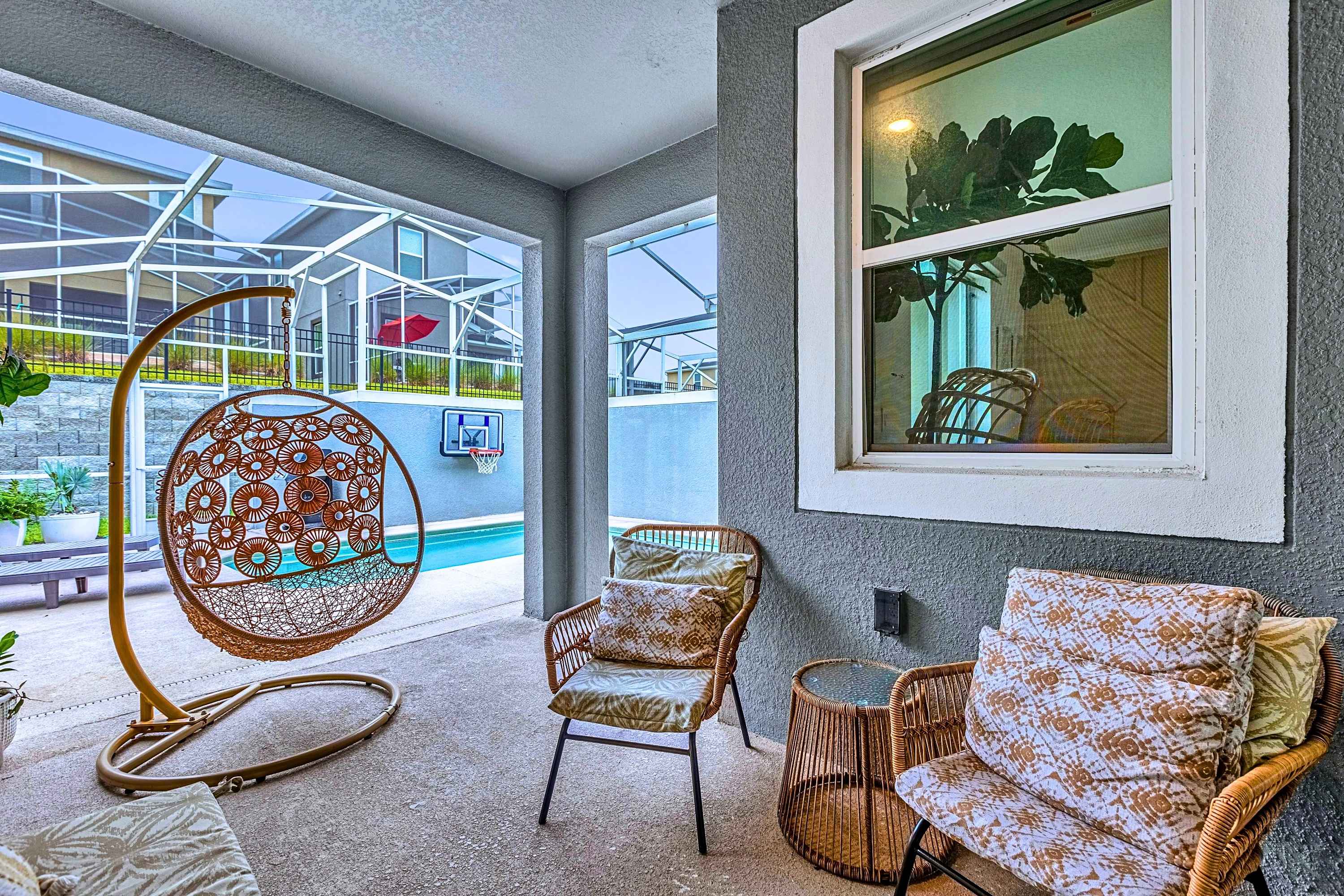 Relaxing outdoor lounge area featuring a comfortable hanging swing chair.