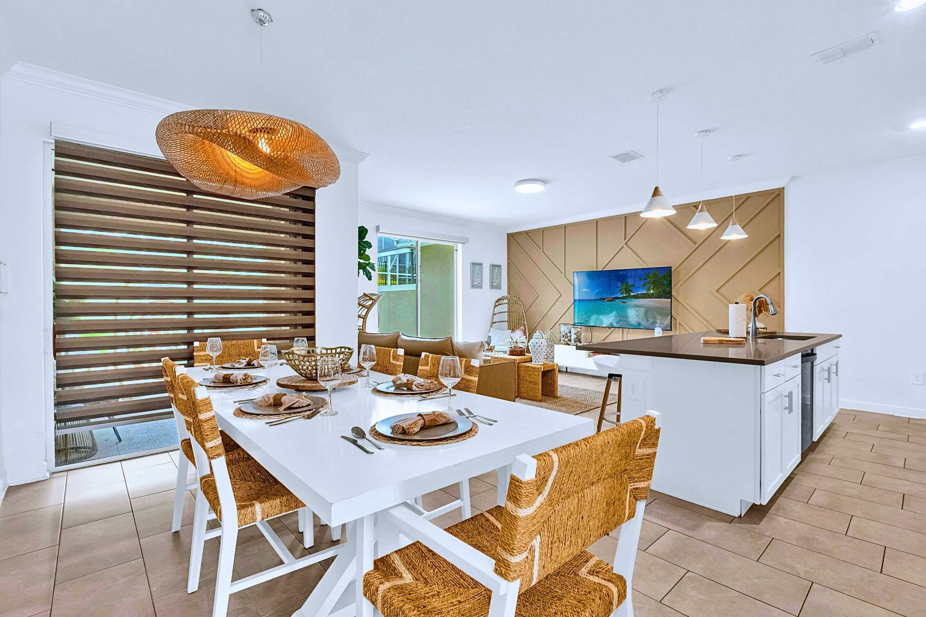 Central dining area featuring an open layout with direct access to the kitchen island and living room.