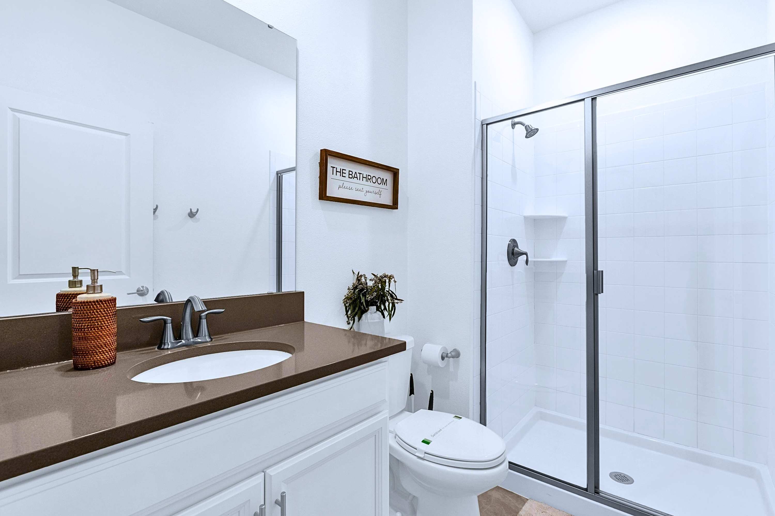 Refresh and recharge in this sleek ensuite bath with a spacious walk-in shower.