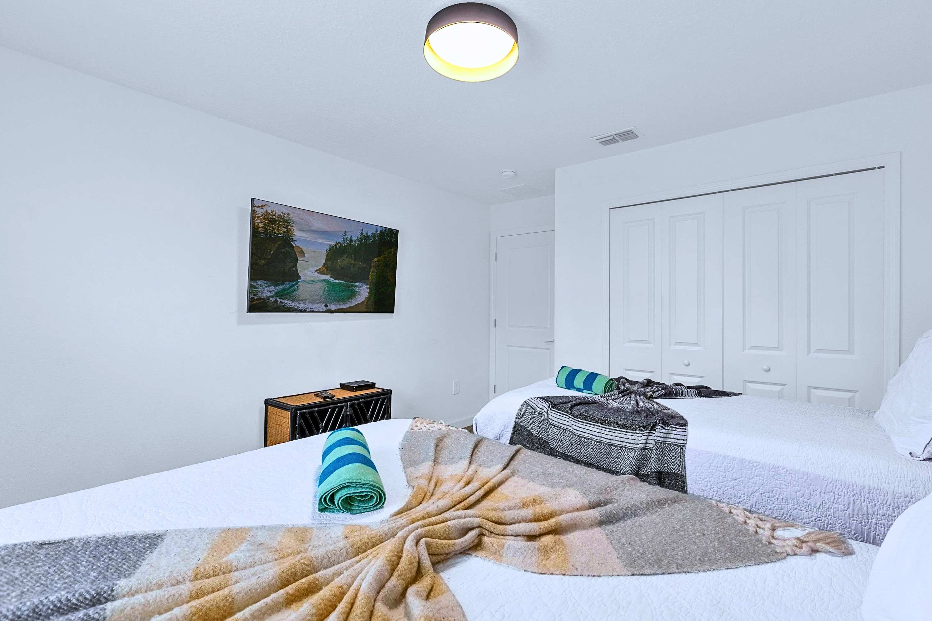 Wind down with a movie from bed in this beautifully styled two-single room.