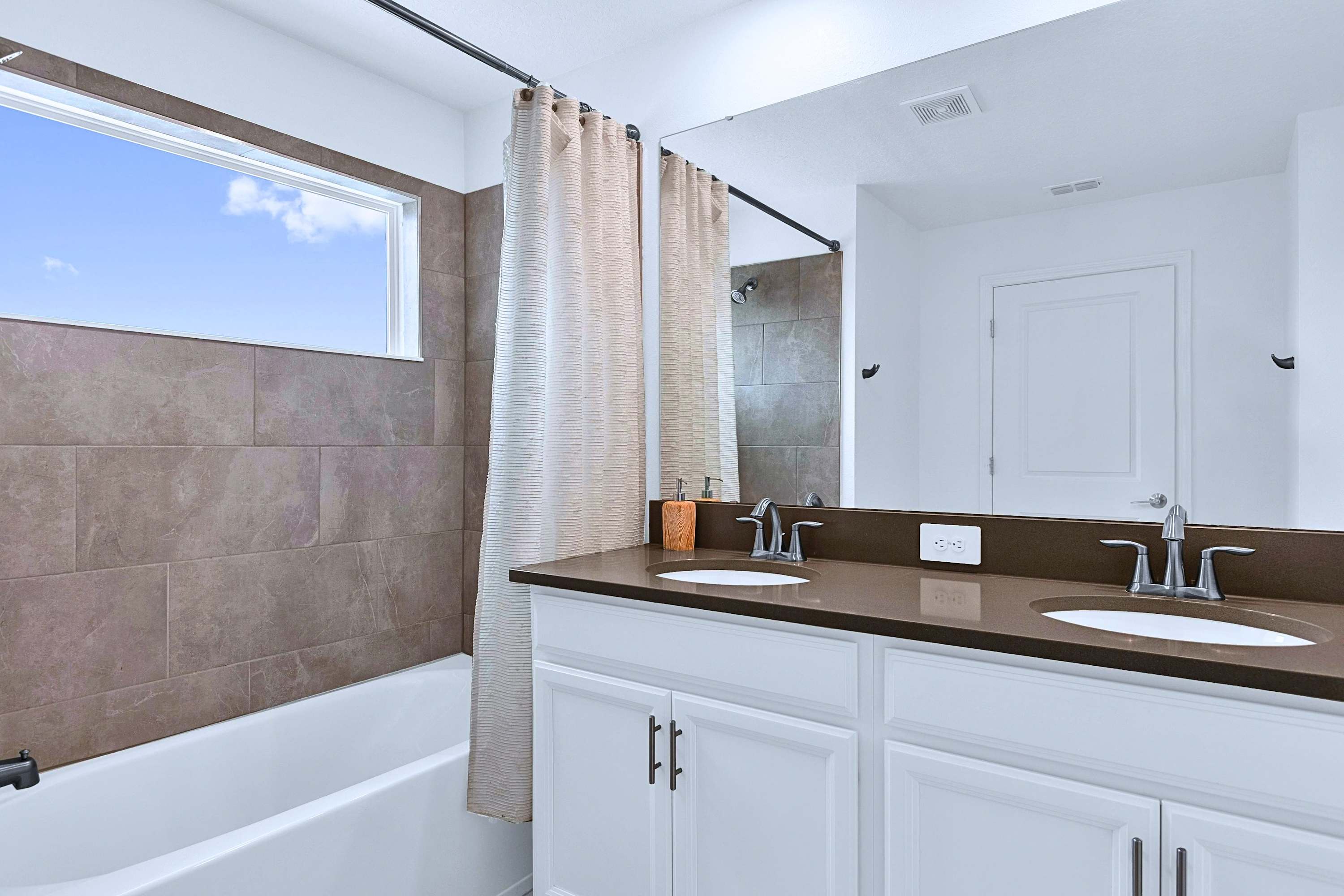 Relax in a warm bath or take a quick shower in this clean, bright full bathroom.
