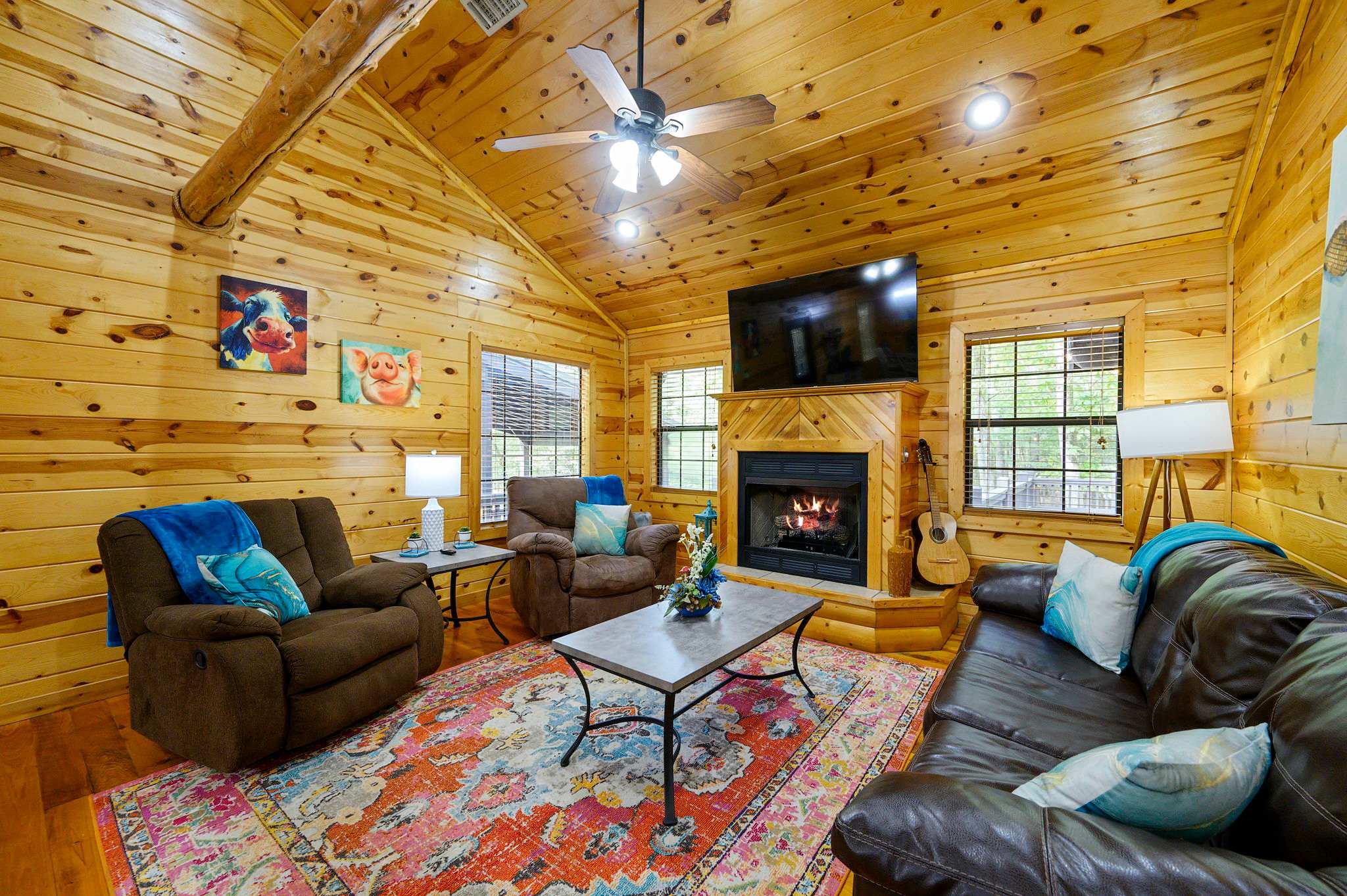 Cozy cabin living room featuring a fireplace, Smart TV, and queen sleeper sofa​
