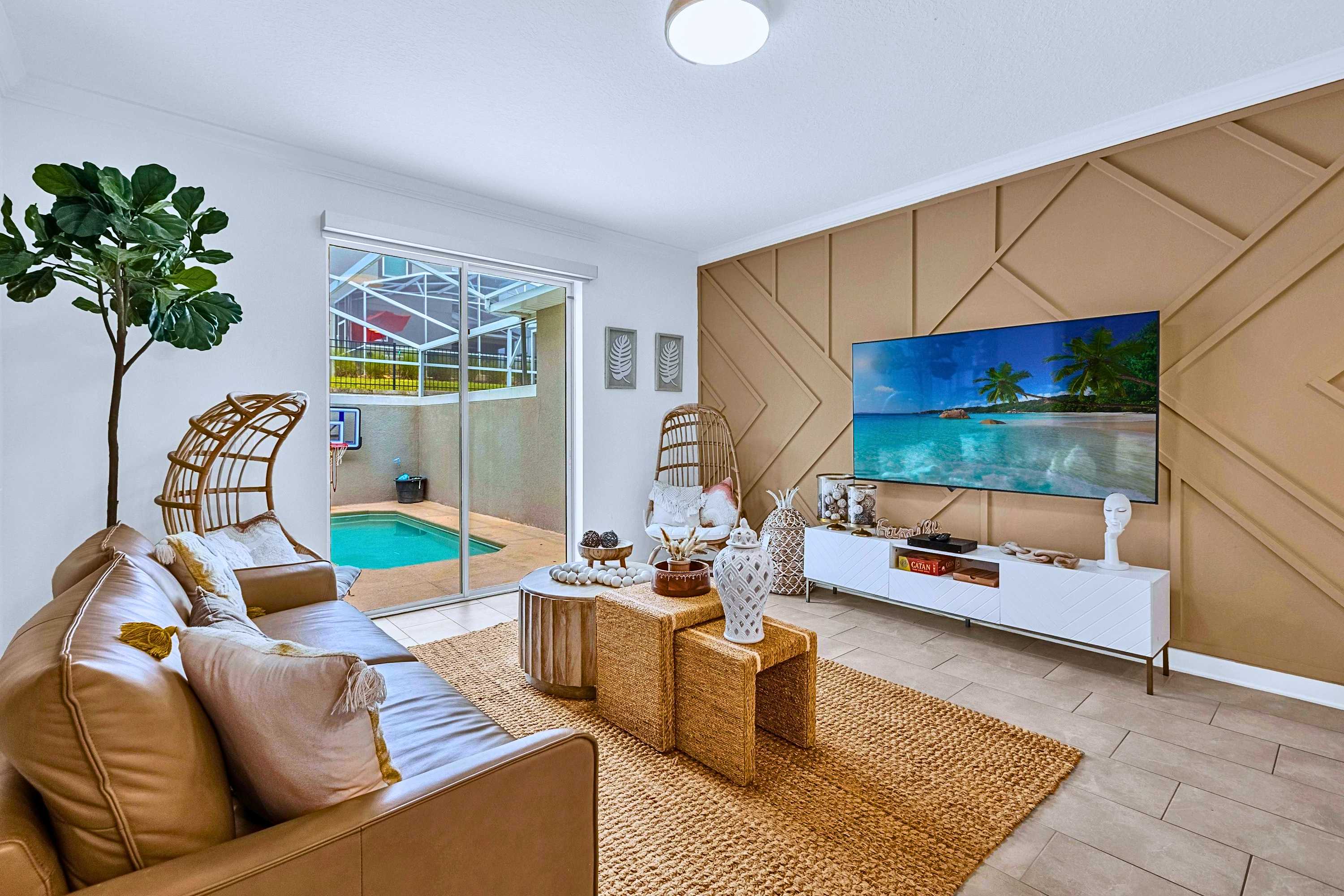 Cozy living room with Smart TV, modern seating, and direct access to your private pool.