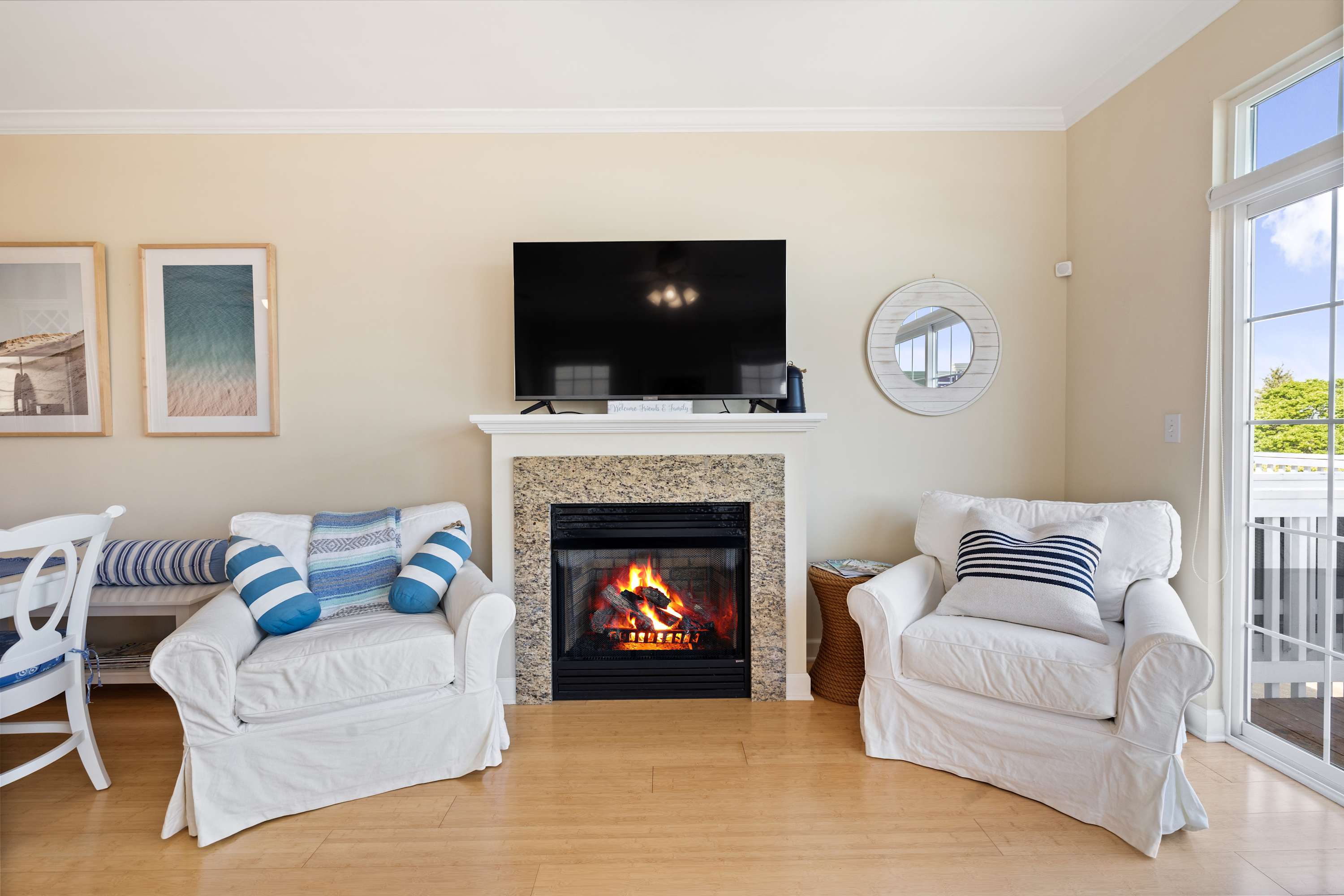 Fireplace, TV, and paired armchairs in a New Buffalo living space.