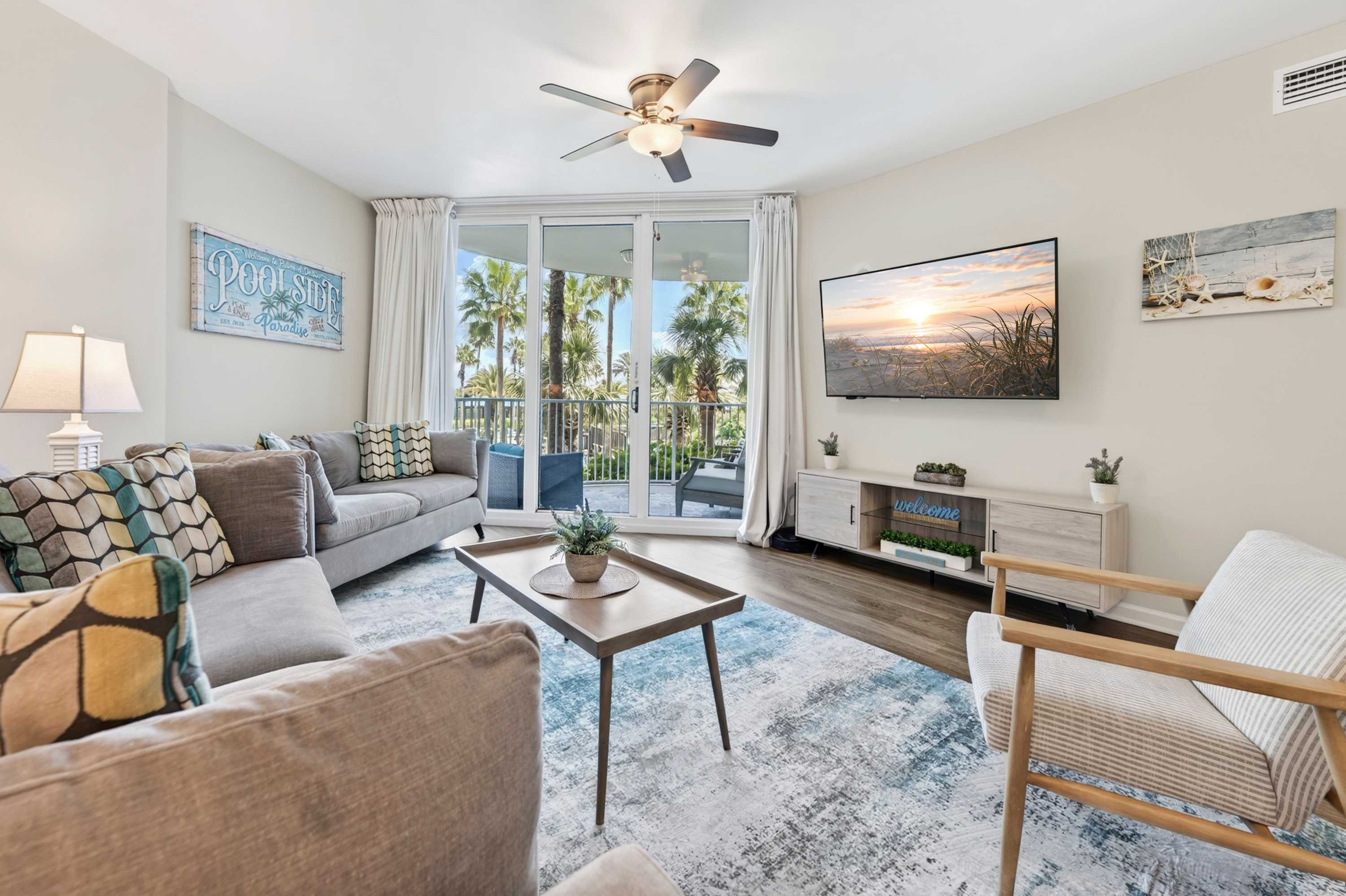 Relax in the living room with a Smart TV, queen sleeper sofa, and sliding-door access to the balcony​