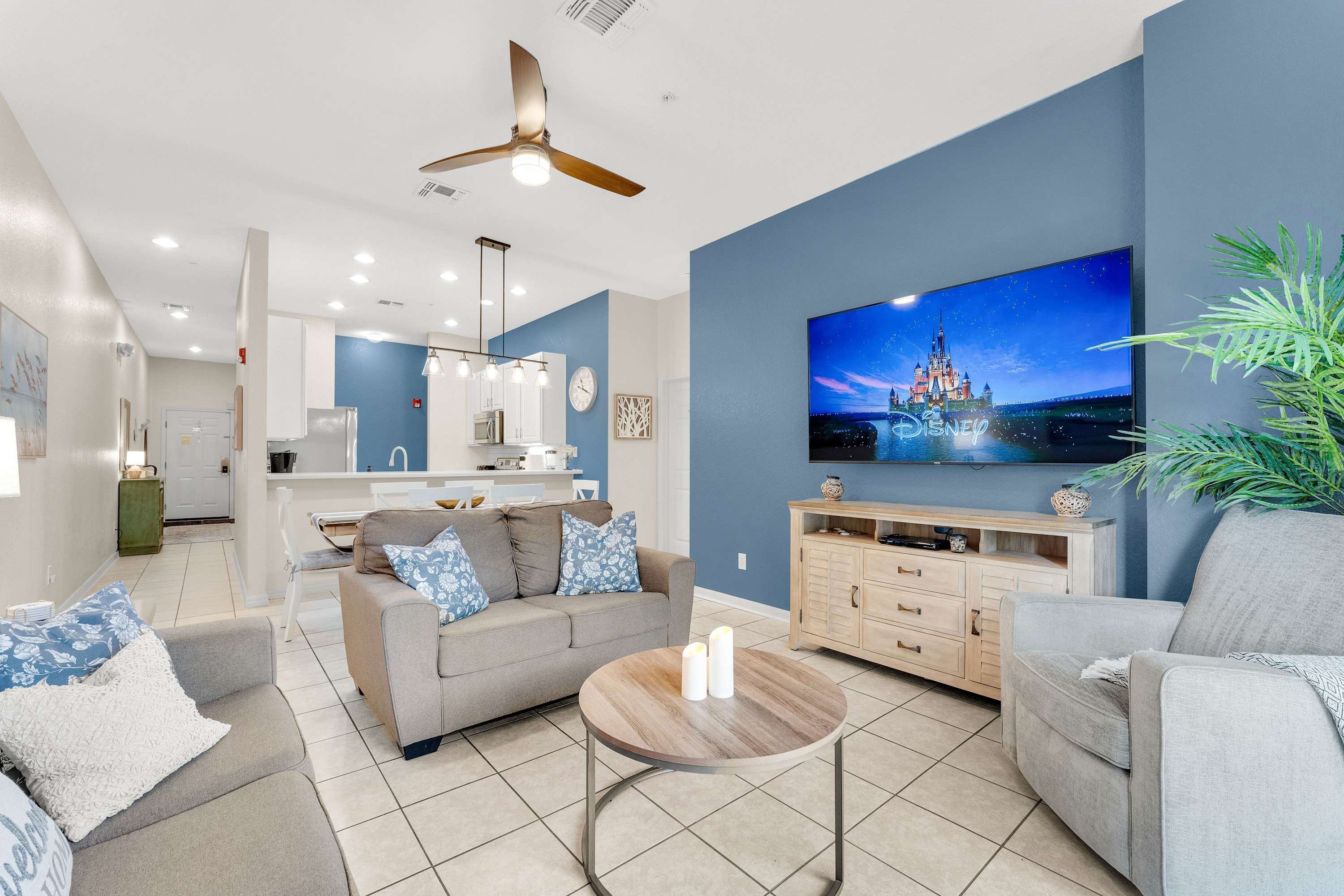 Enjoy the bright living space with comfortable couches, Roku Smart TV, and access to the screened-in porch​