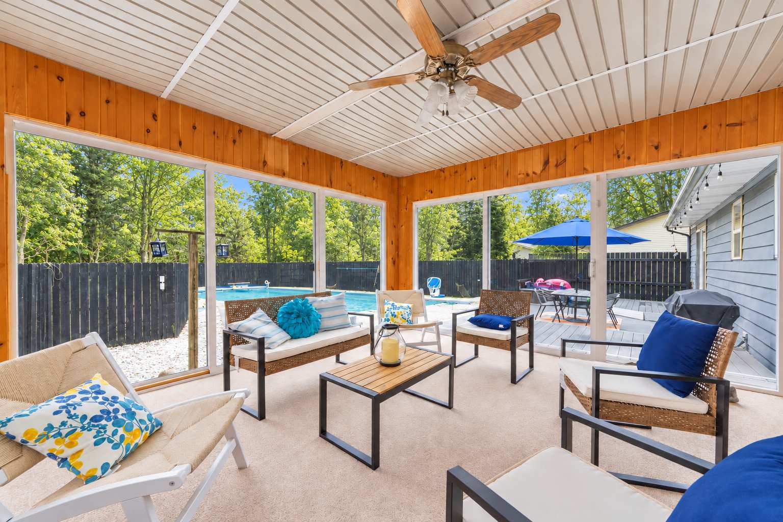 The sun porch offers a breezy spot to relax with a view of the pool