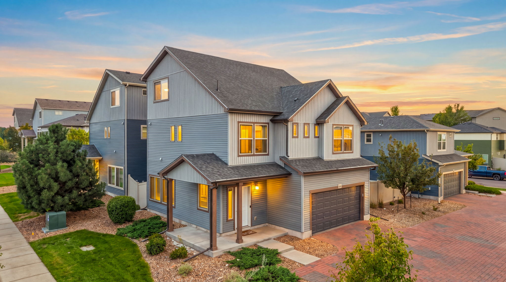 Corner-lot home with a landscaped yard and private paver driveway