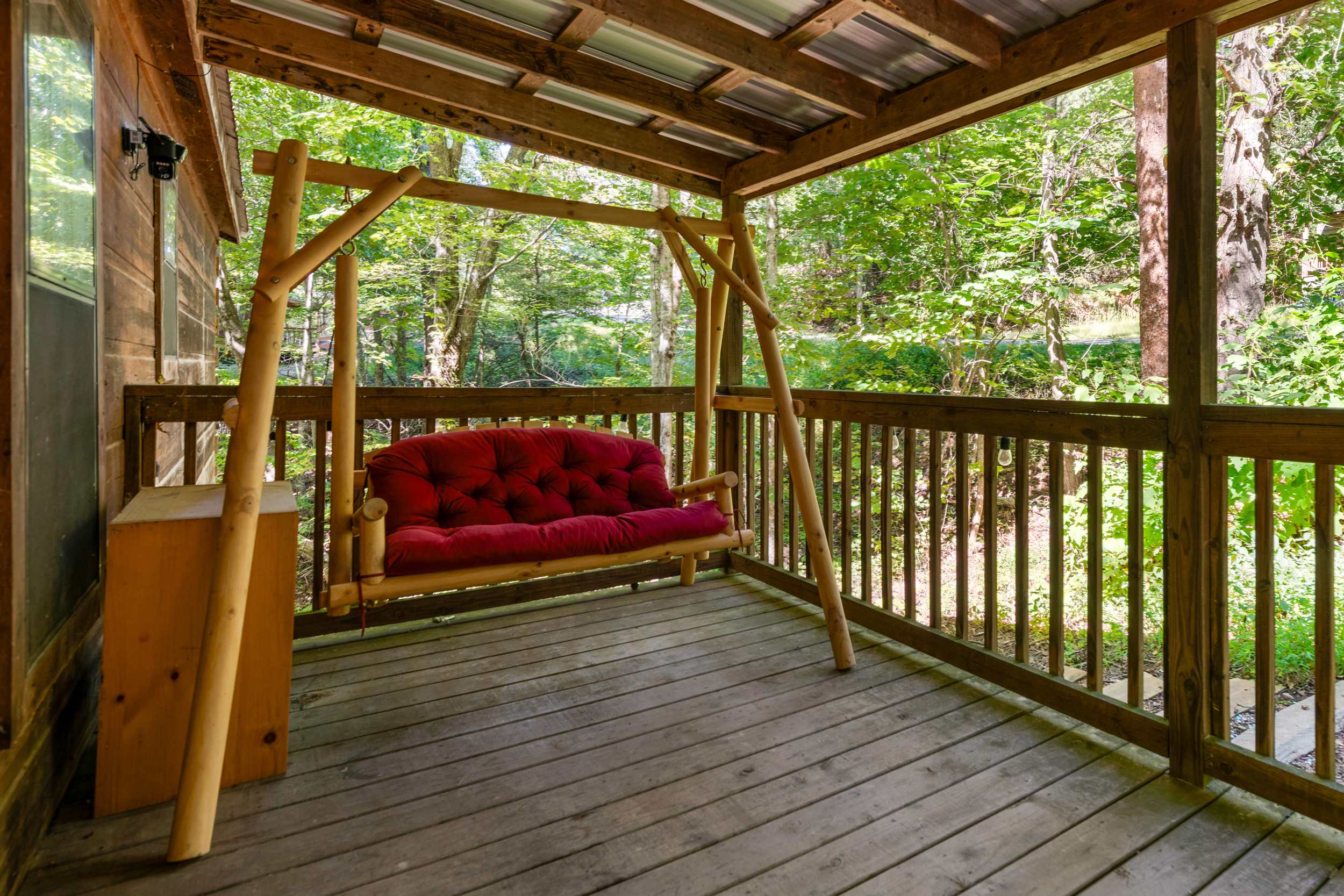 Relax on the shaded porch swing while taking in the surrounding nature views. 