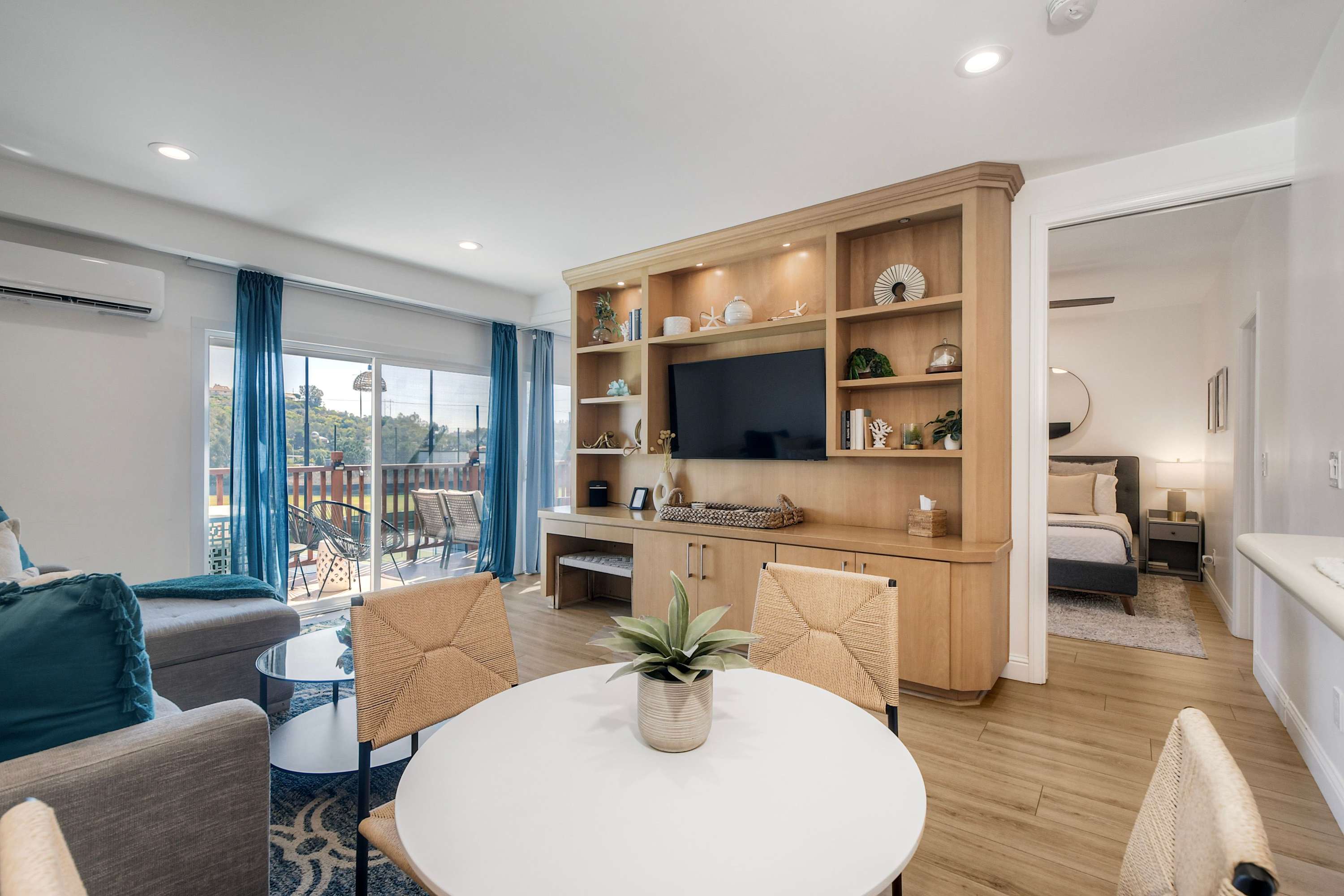 Relax in the open living room with a Smart TV, full sleeper sofa, and sliding-door balcony access
