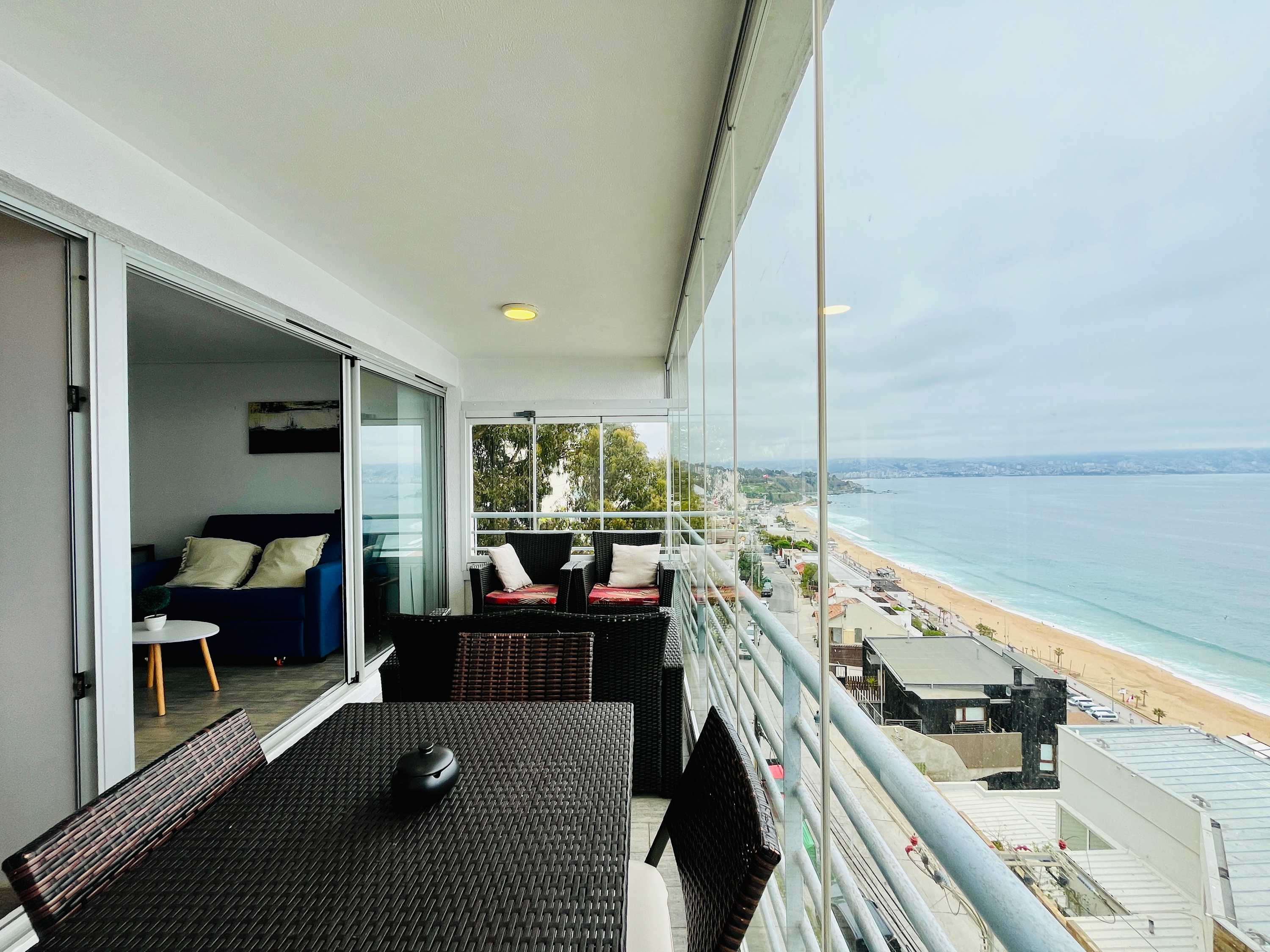 Glass-enclosed terrace overlooking the beach and bay