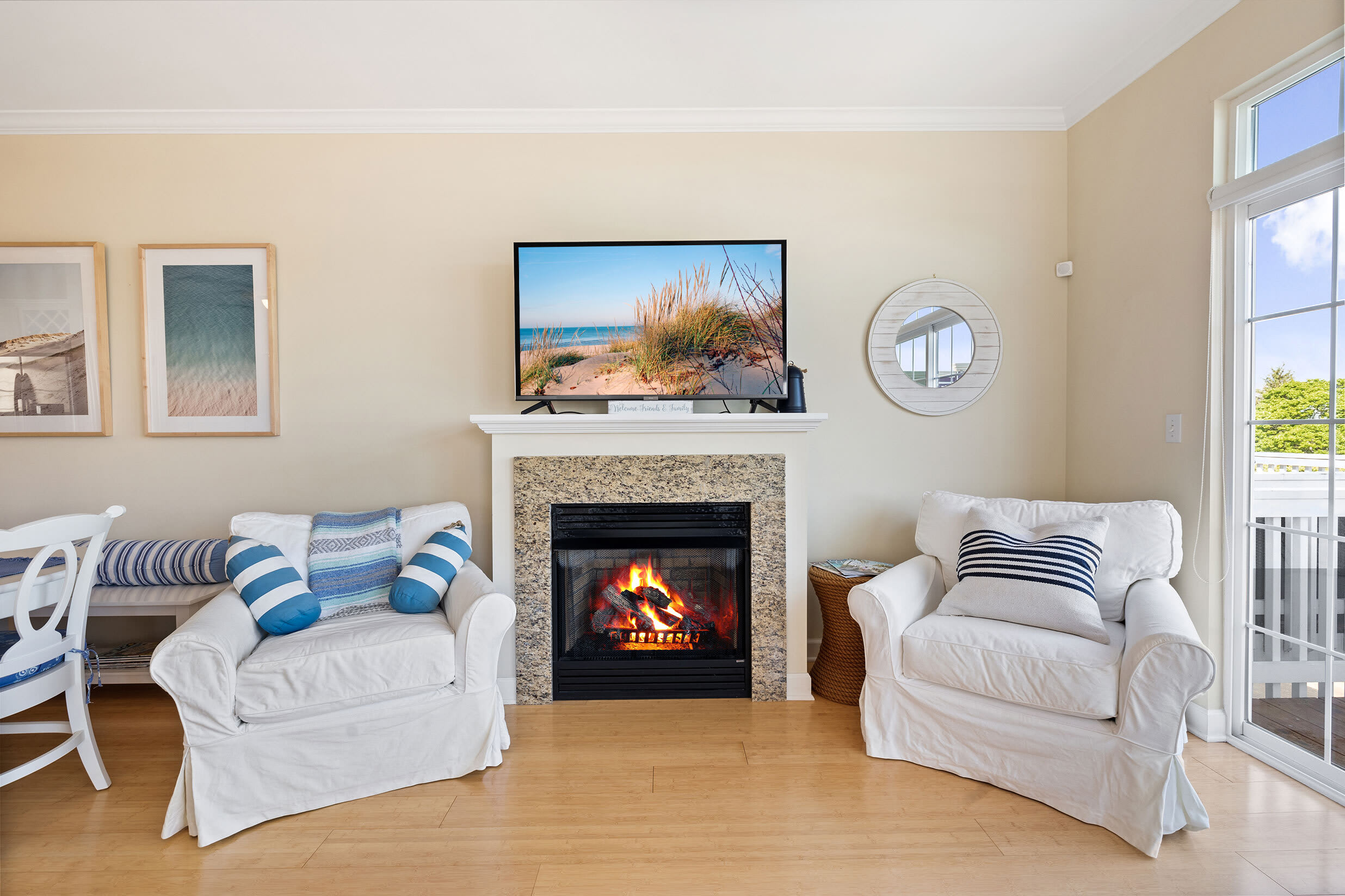 Fireplace, TV, and paired armchairs in a New Buffalo living space.