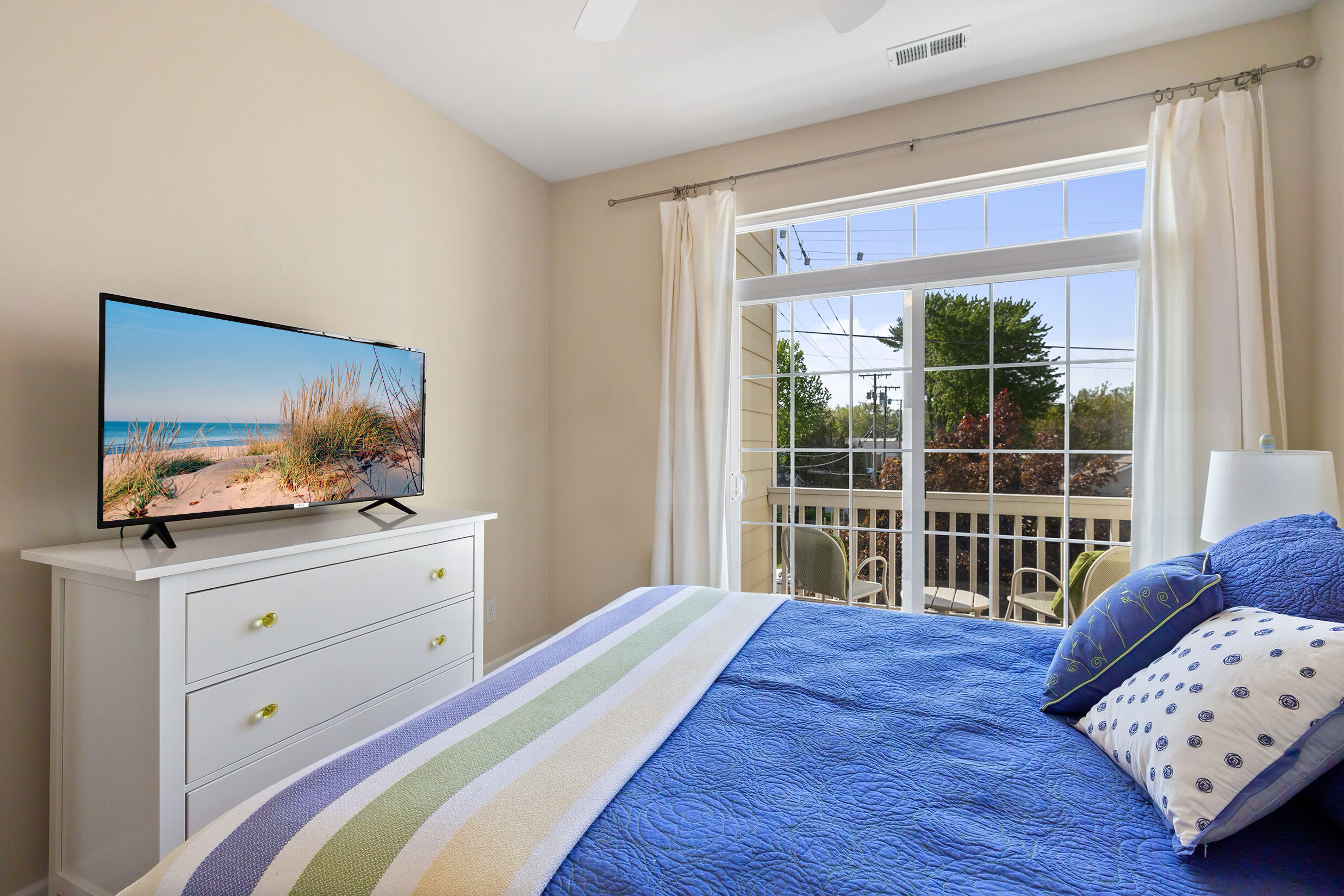 Bedroom with balcony doors and full curtains for privacy at night.