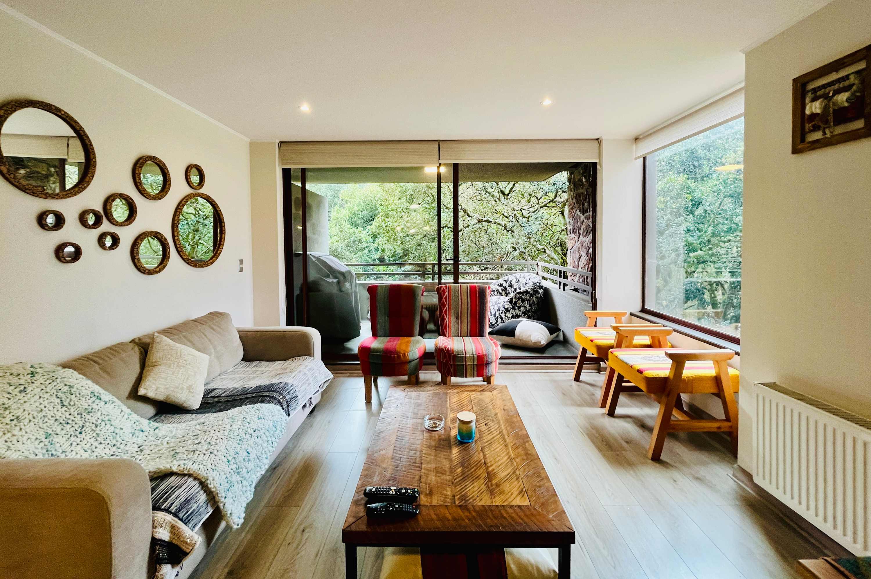 Living room opening onto the terrace with forest views