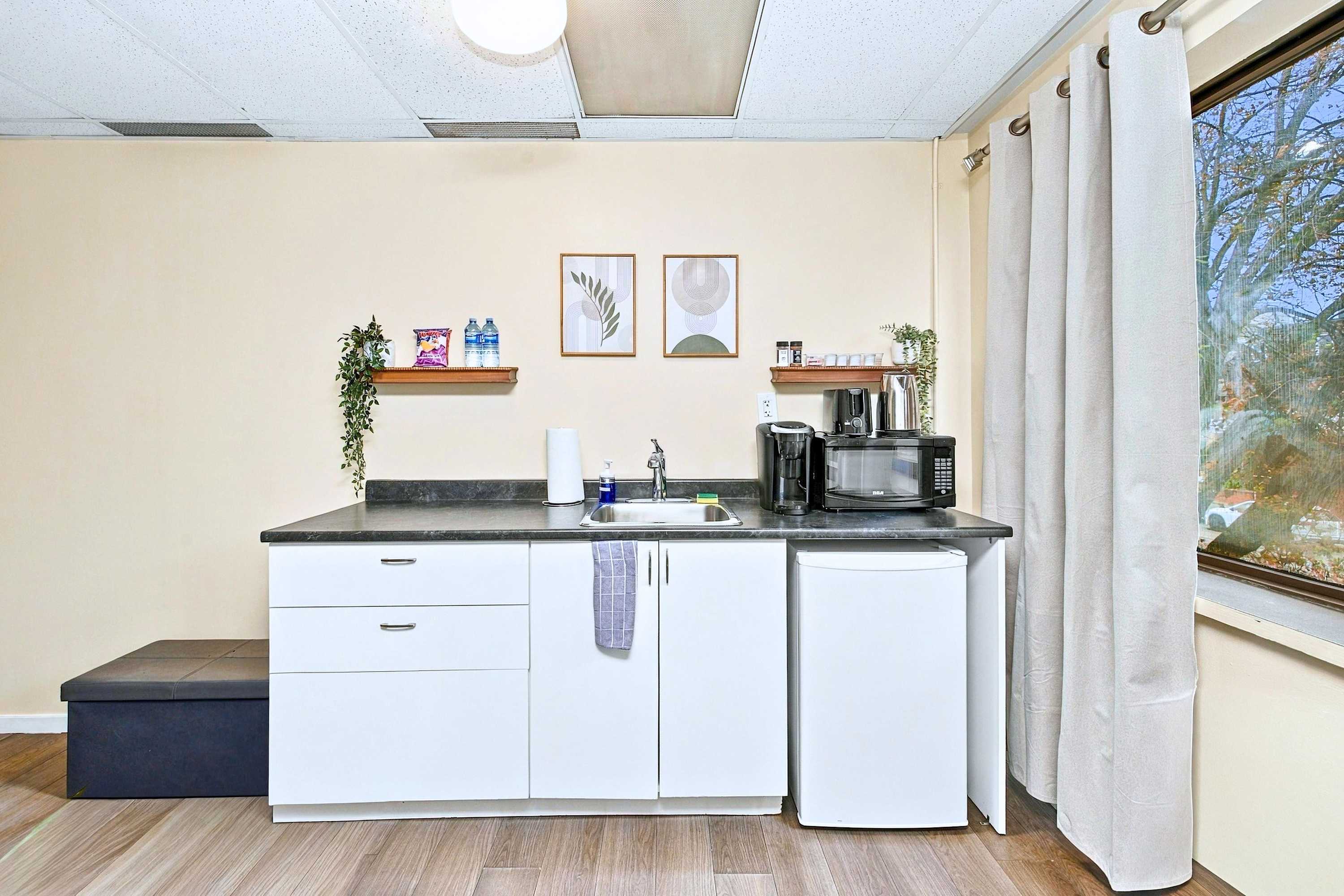 Kitchenette with mini fridge and microwave oven