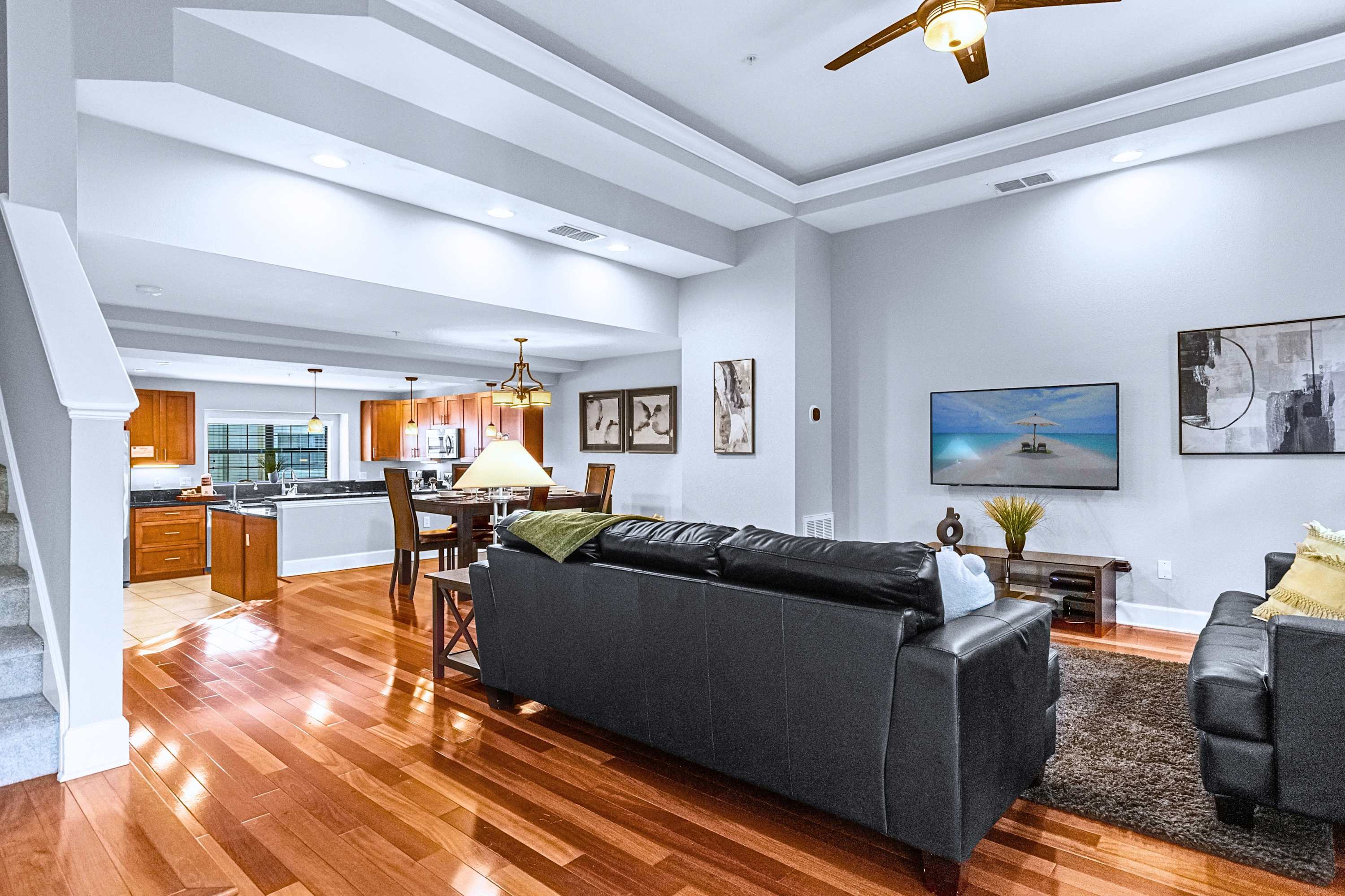 A bright and open living area featuring high ceilings and comfortable seating