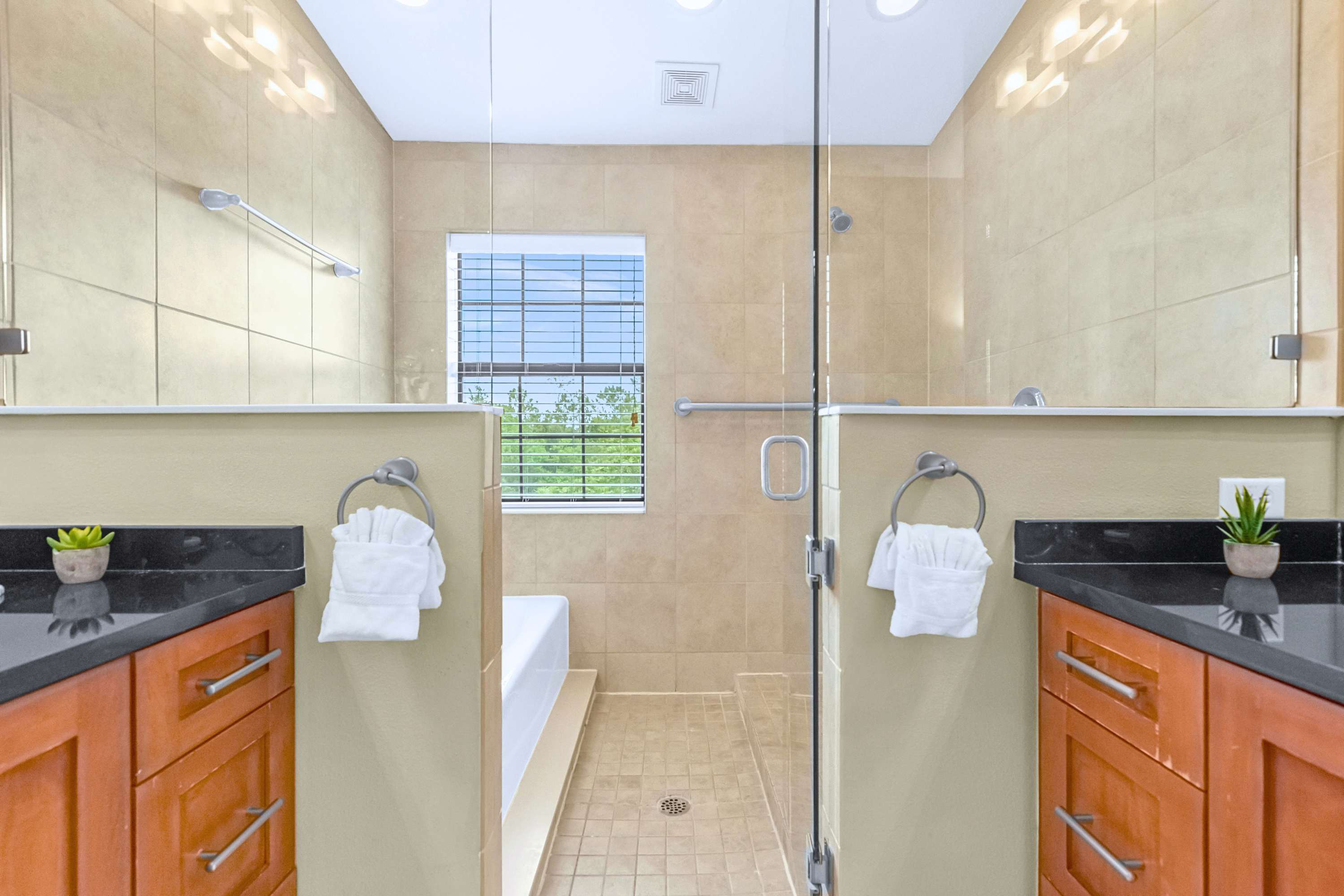 A sleek en-suite bathroom showcasing modern tile finishes and glass doors