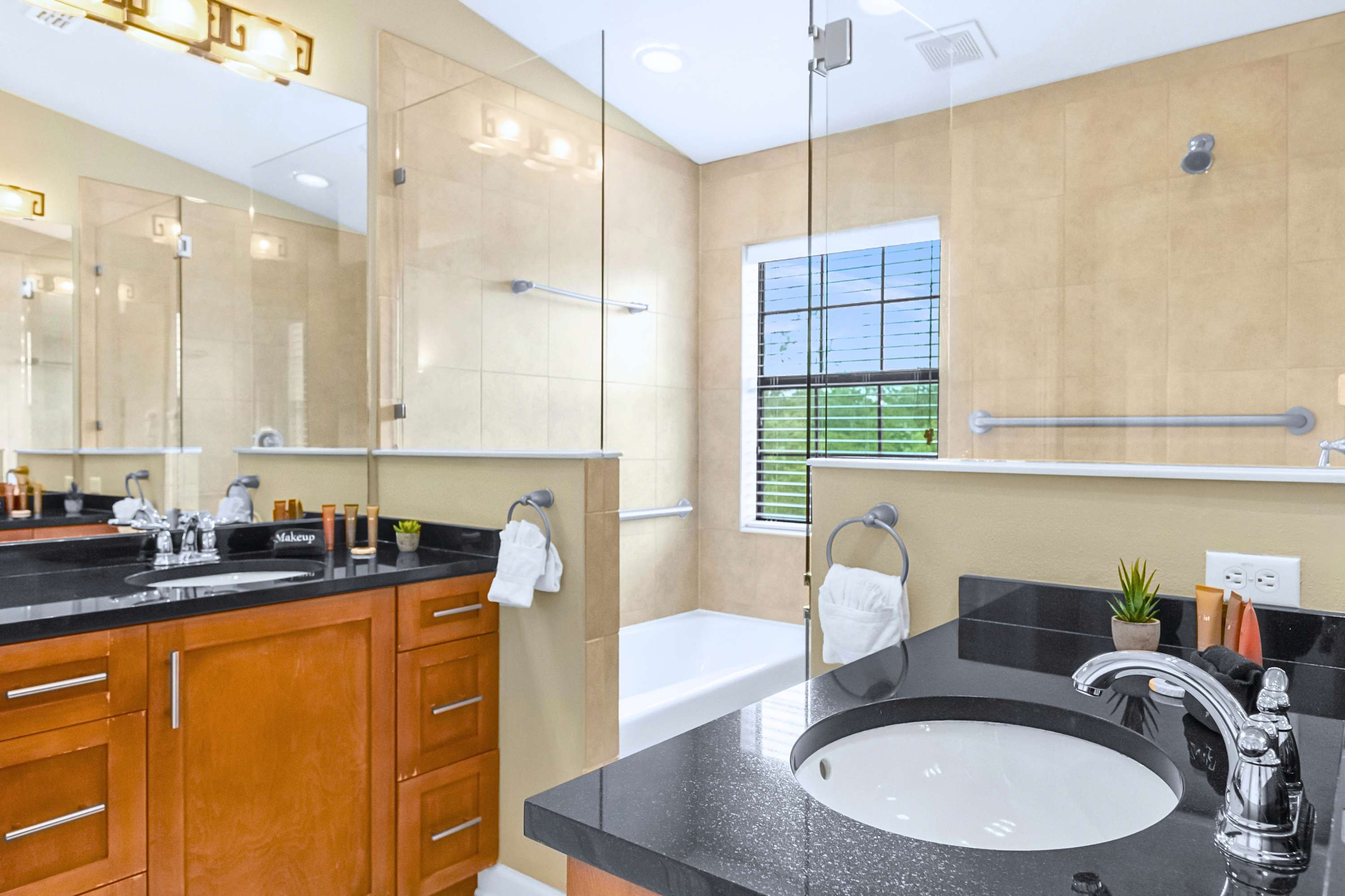 Spacious bathroom suite featuring a double vanity with ample lighting