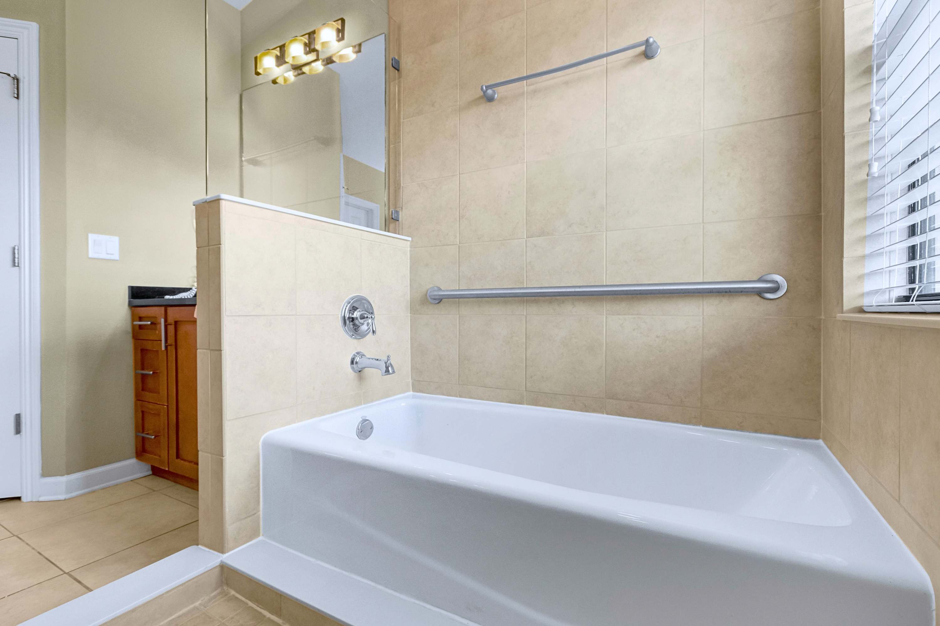 Bathroom layout complete with a deep soaking tub and tile finish