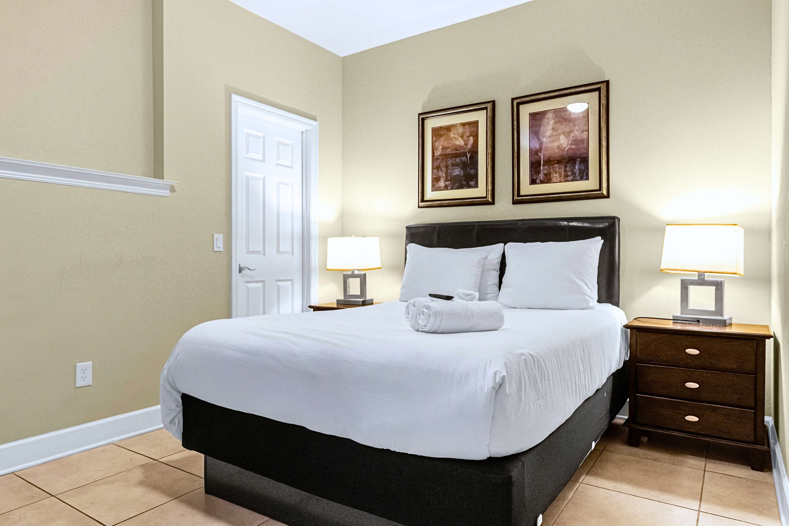 A calm guest bedroom styled with minimal decor and crisp white linens
