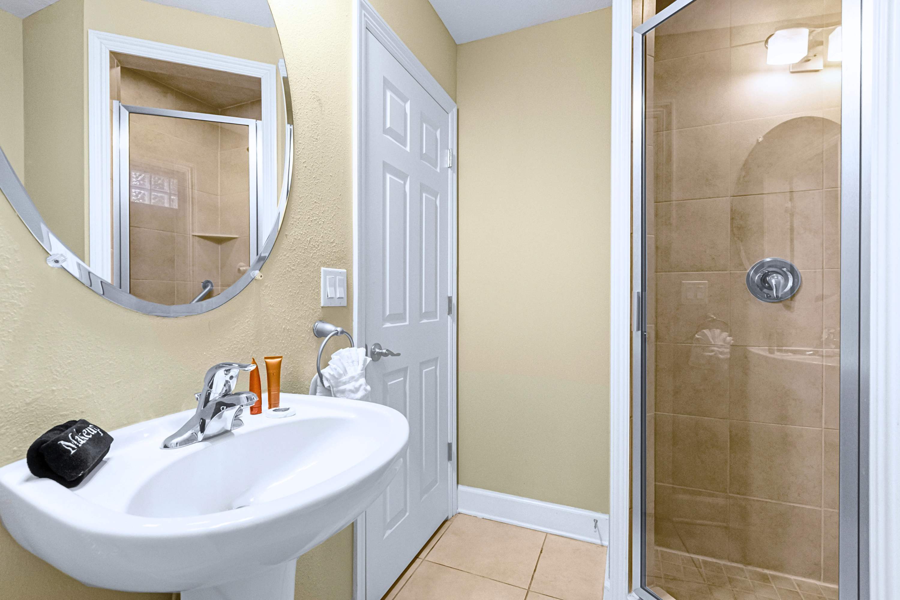 Refresh in style with a crisp mirror, sleek sink, and walk-in shower.