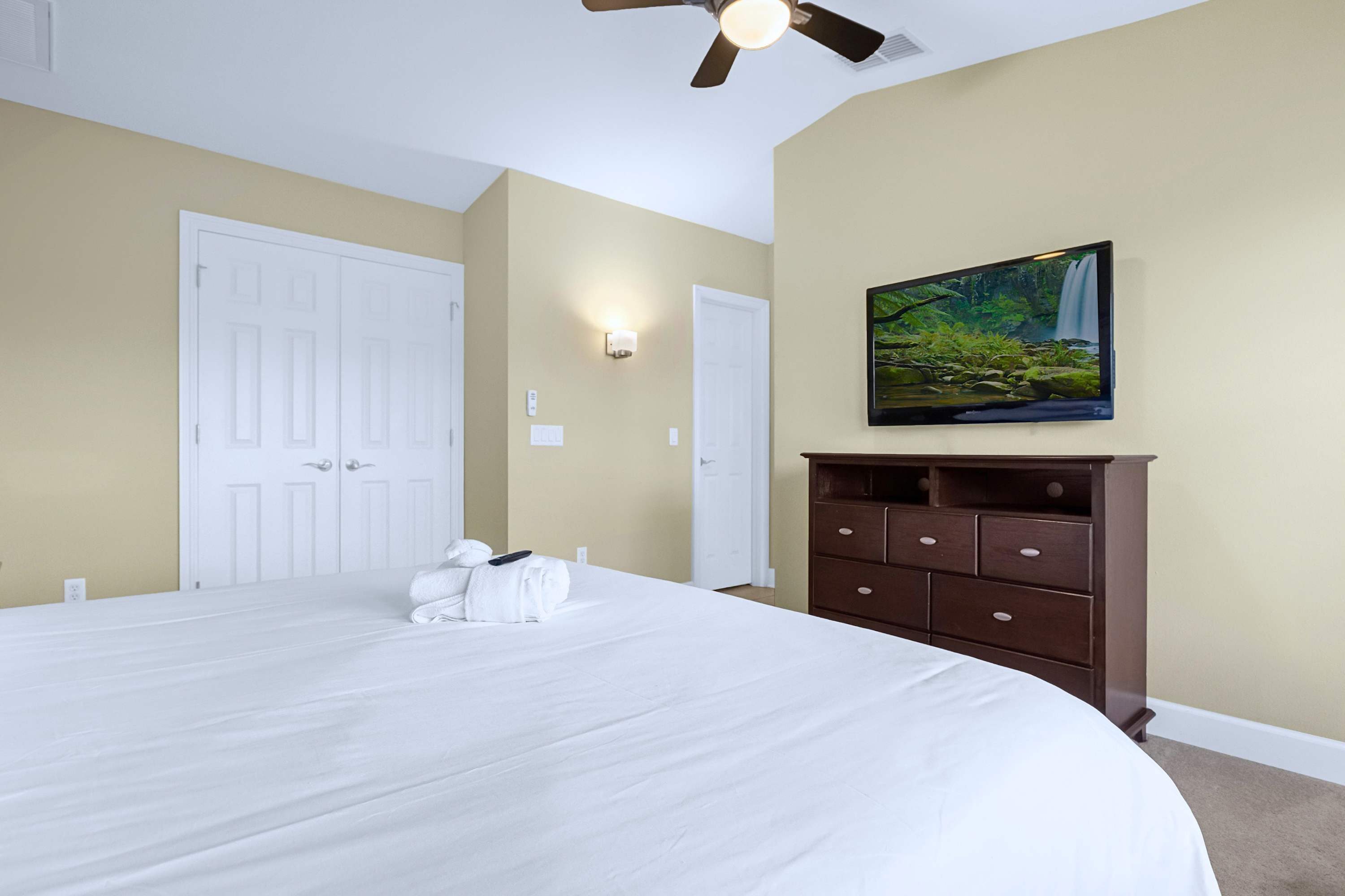 Comfortable guest suite featuring a wall-mounted TV for private entertainment