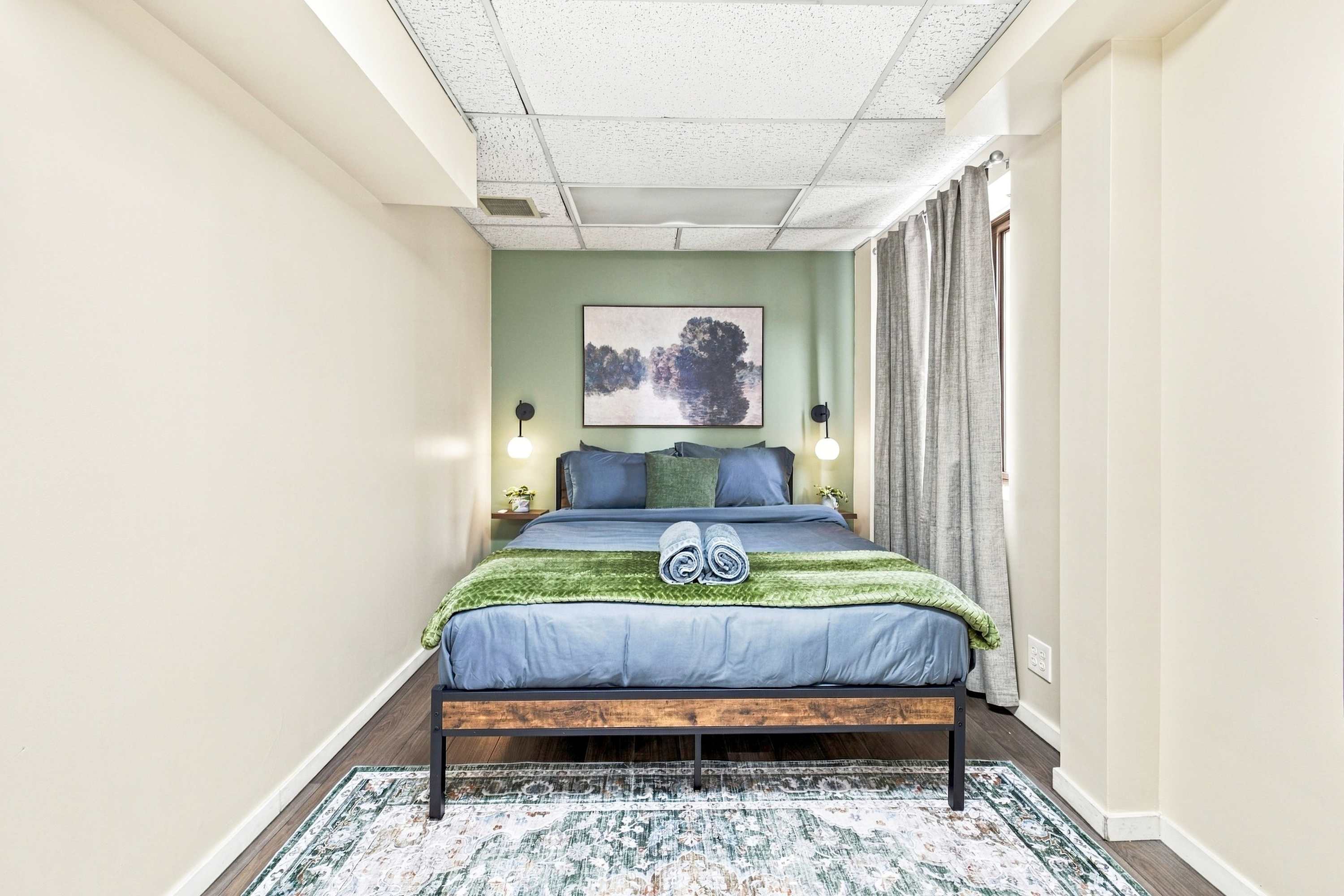 Rest easy with crisp linens, warm bedside light, and plush queen comfort.