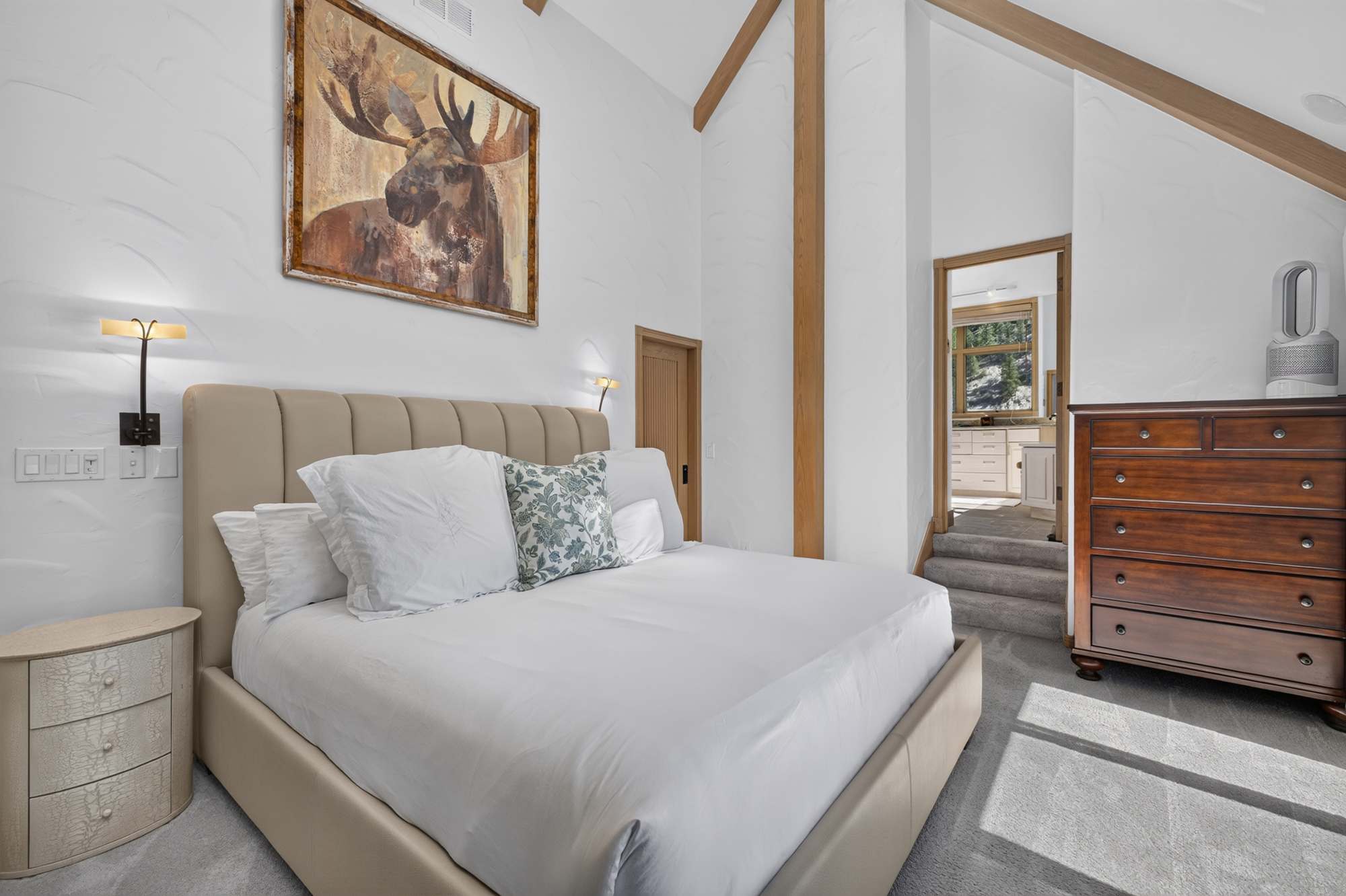 Relax in the king bedroom with a Smart TV, ensuite bathroom, and deck access