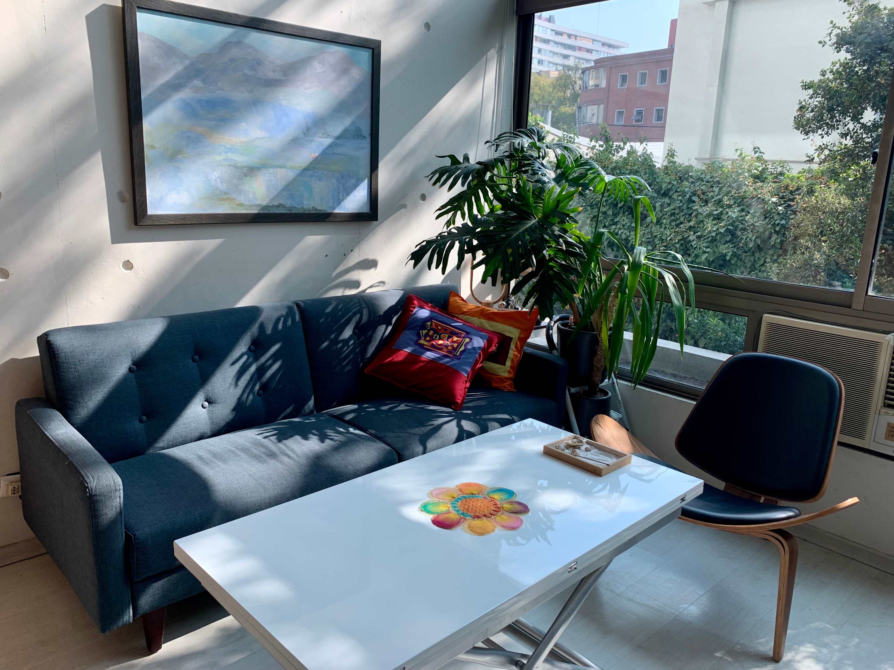 Bright living area with sofa, white table and large window