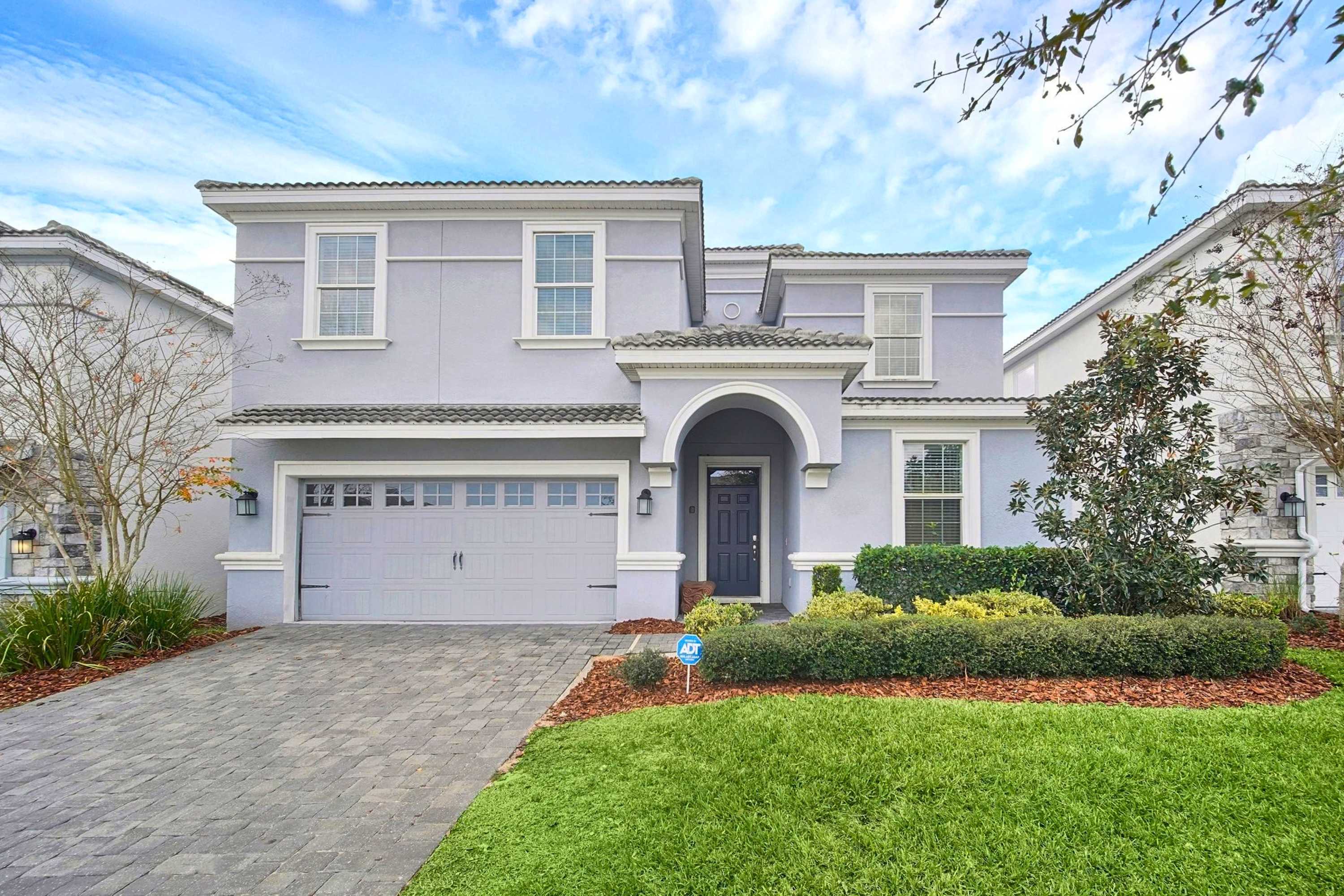 Front view of the two-story vacation home with driveway.