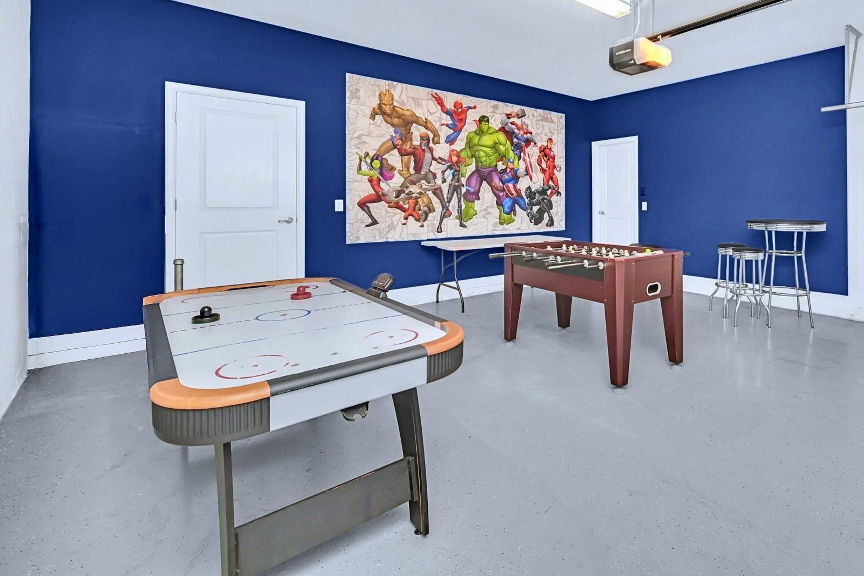 Game room equipped with an air hockey table and pool table.