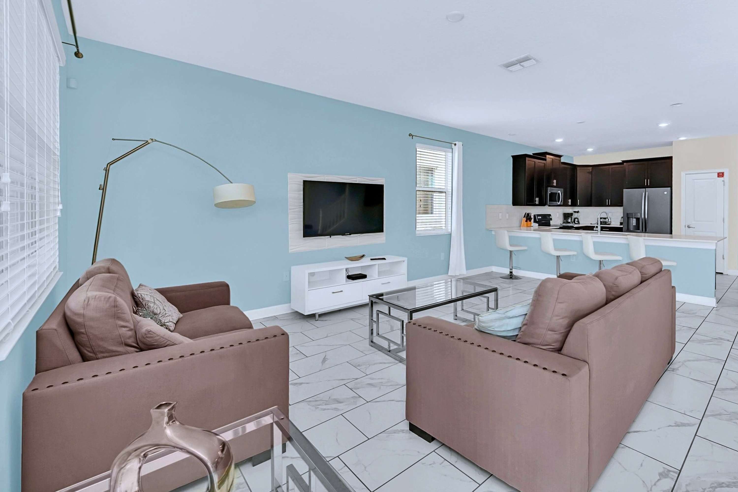 Bright open-concept living area with comfortable plush seating.