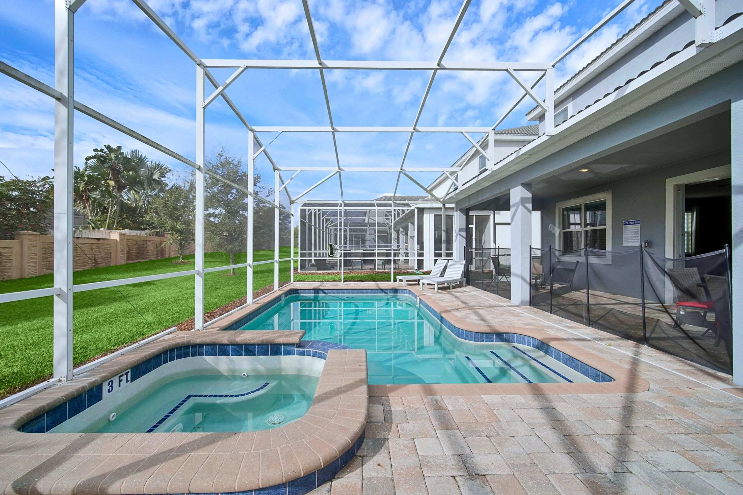 Private enclosed pool deck featuring a raised heated spa.