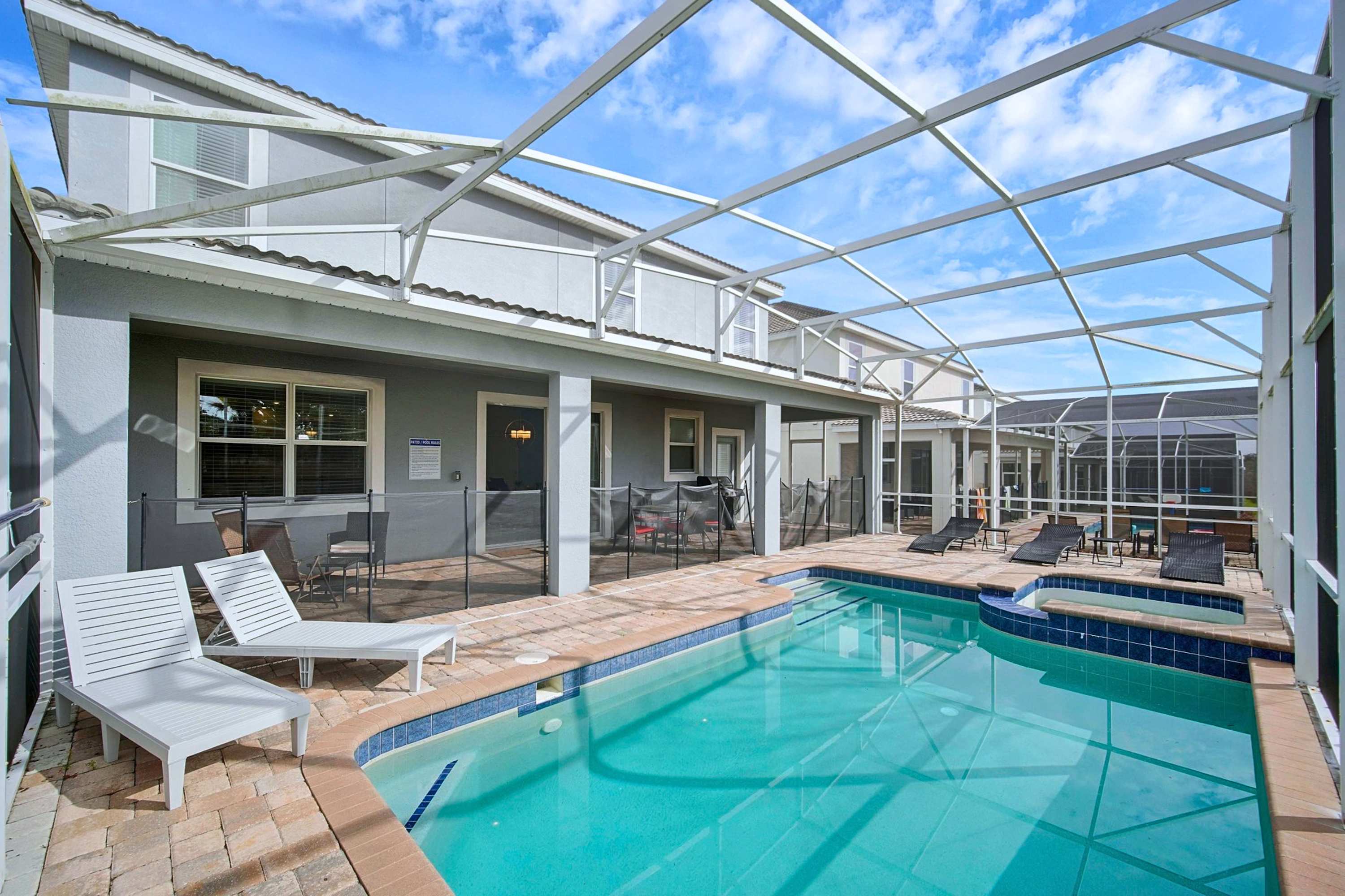 Spacious outdoor pool patio with full screen enclosure.