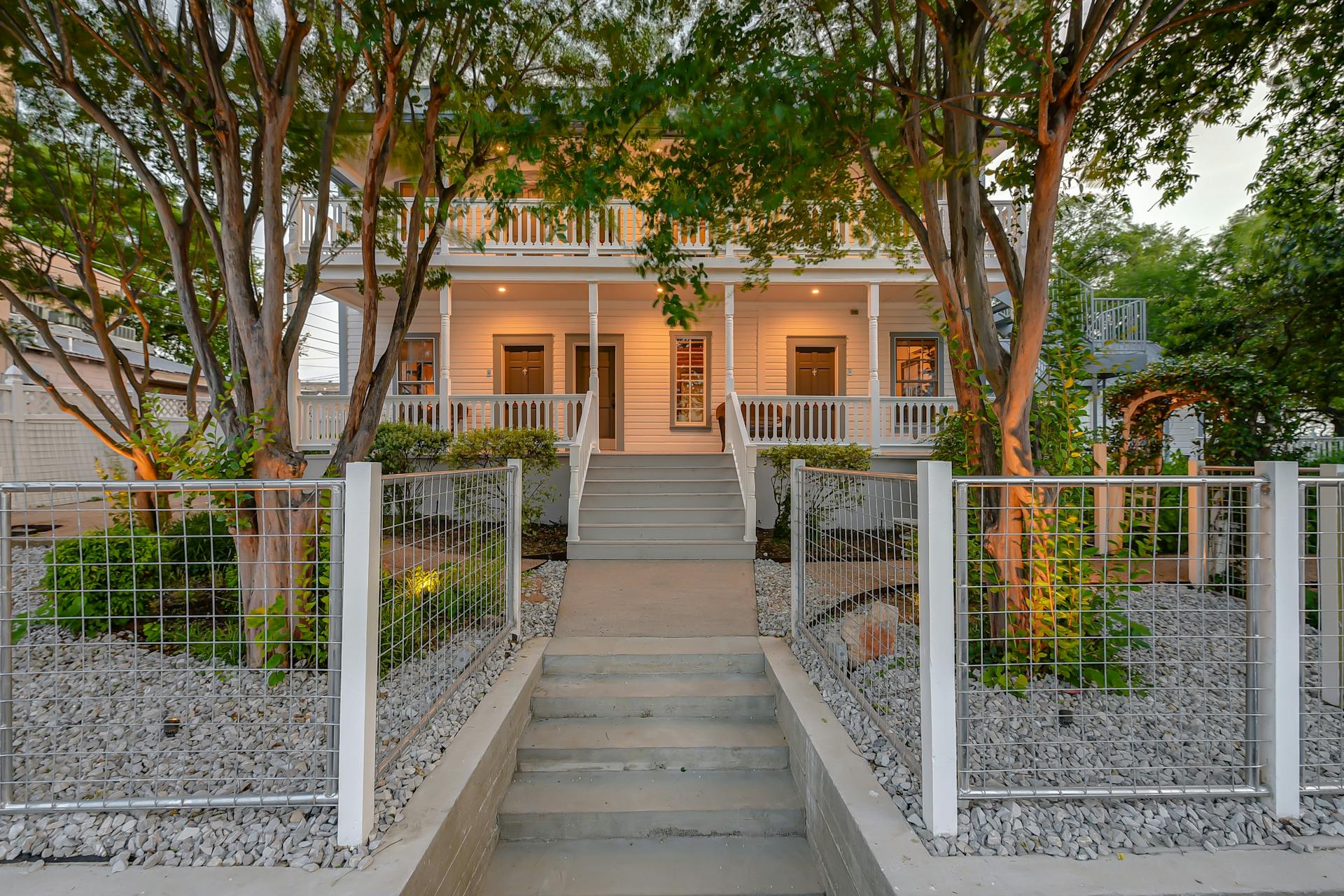 Welcome home to this charming, tree-lined two-story retreat with a warm, illuminated entryway.