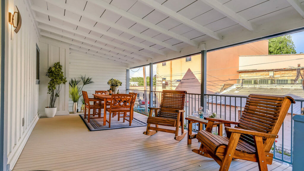 Unwind on the private covered deck featuring cozy rocking chairs and an outdoor dining area.