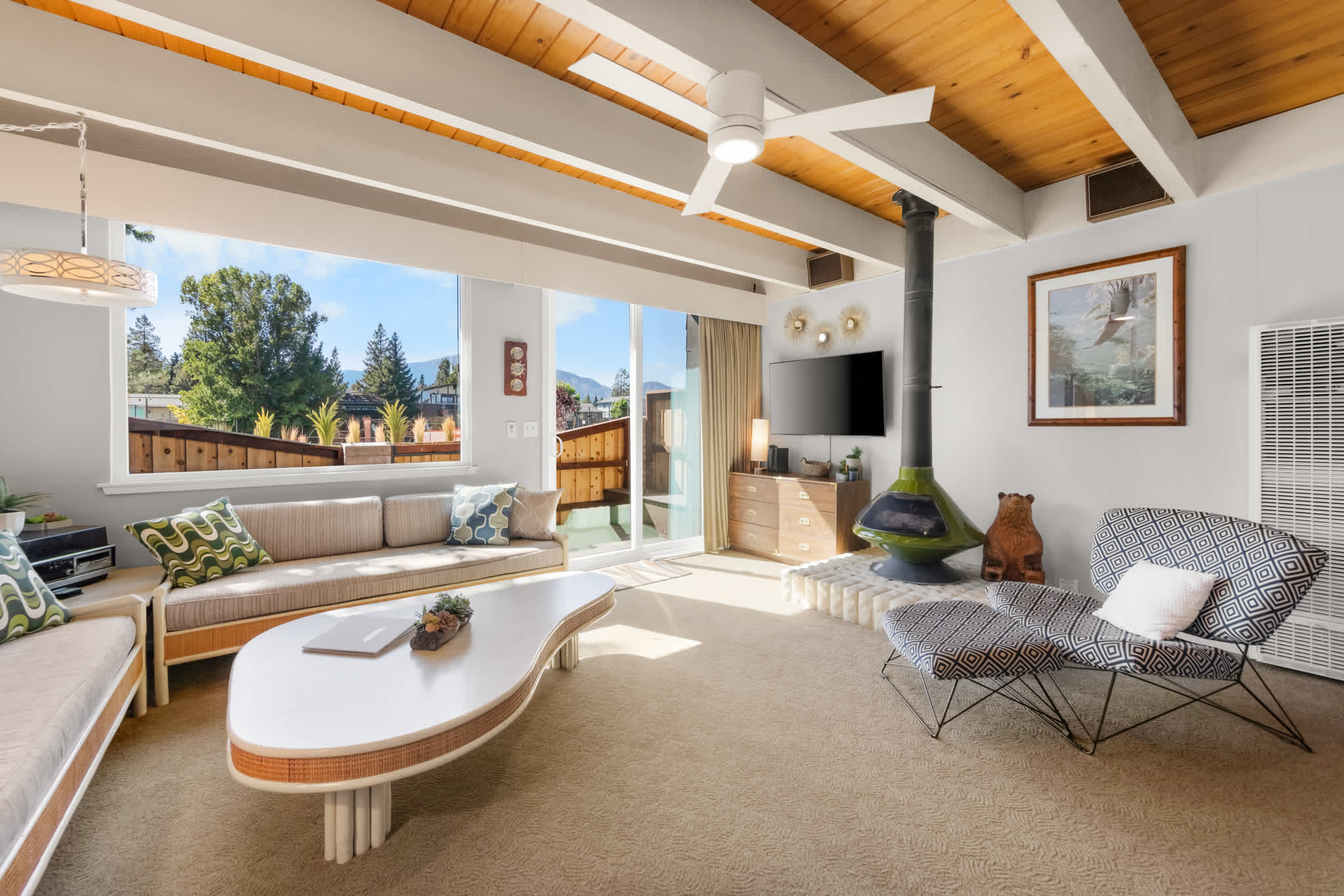 Retro-inspired living room with two sofas, accent chairs, a smart TV, and a gas fireplace