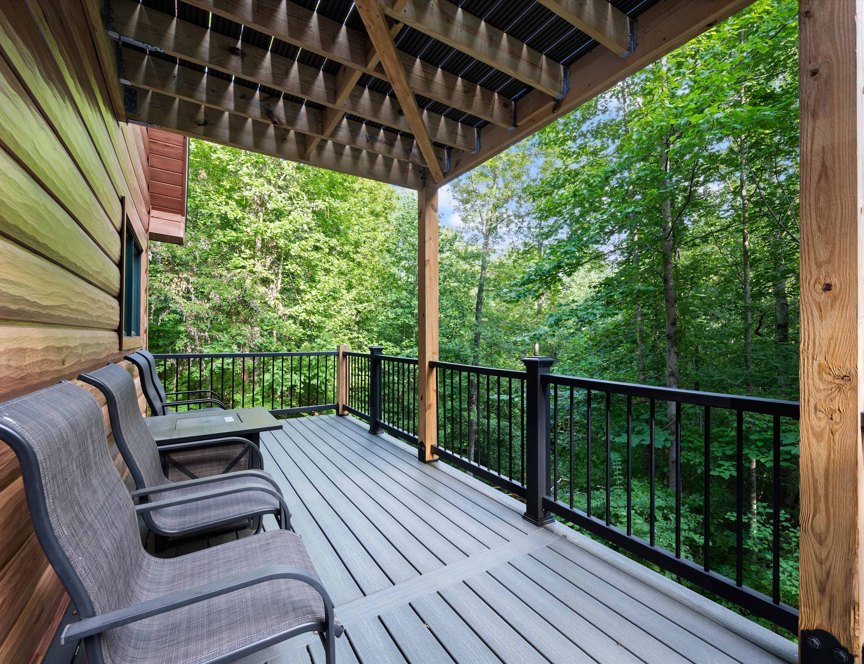 Secluded deck with inviting outdoor seating and beautiful tree-lined views