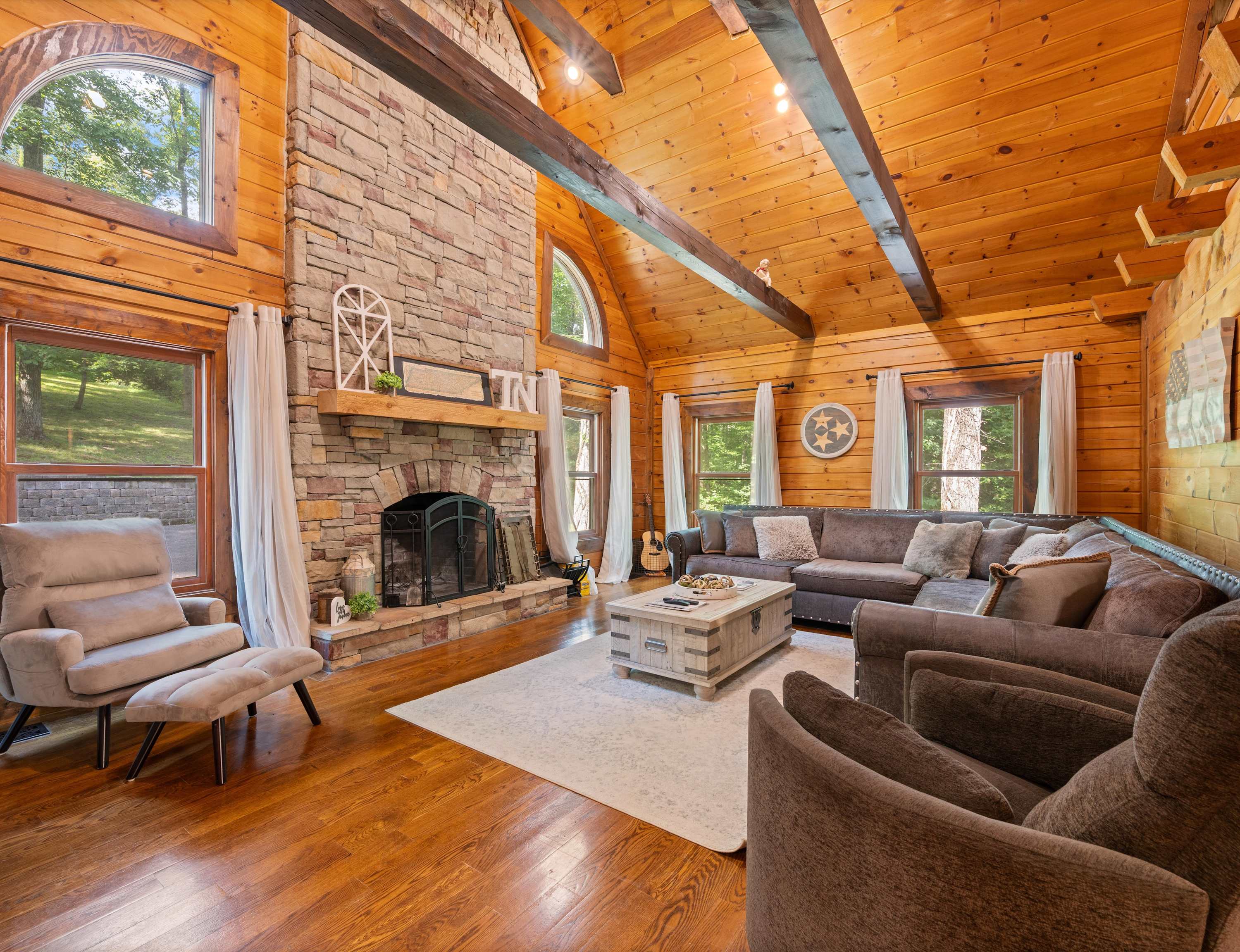 Gather and make memories in the bright, open cabin living room with high ceilings and a spacious sectional