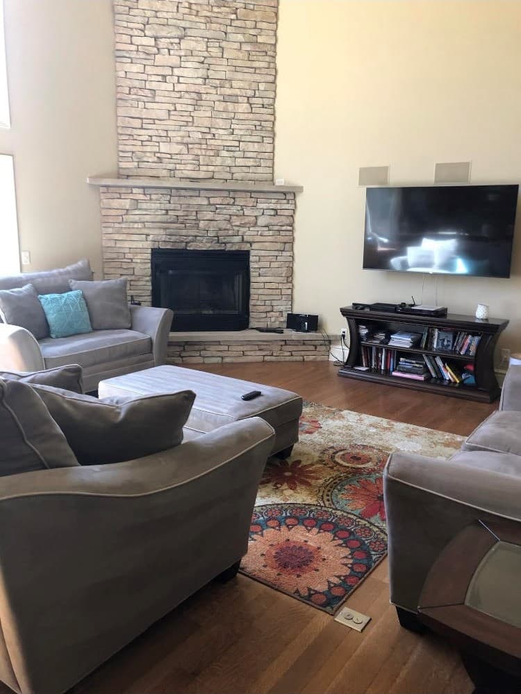 Comfortable seating beside the stone fireplace
