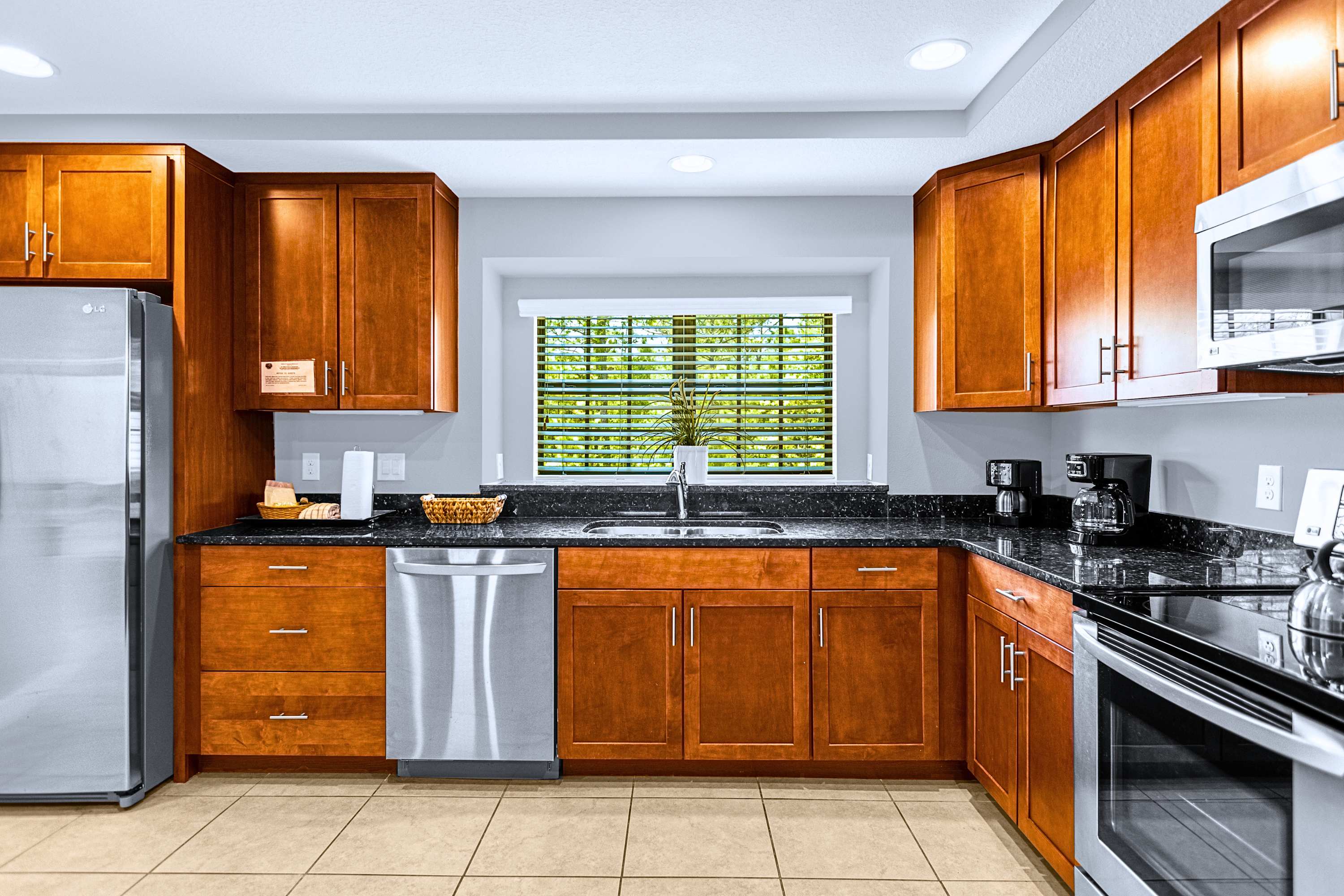 A modern, fully equipped kitchen featuring sleek granite countertops