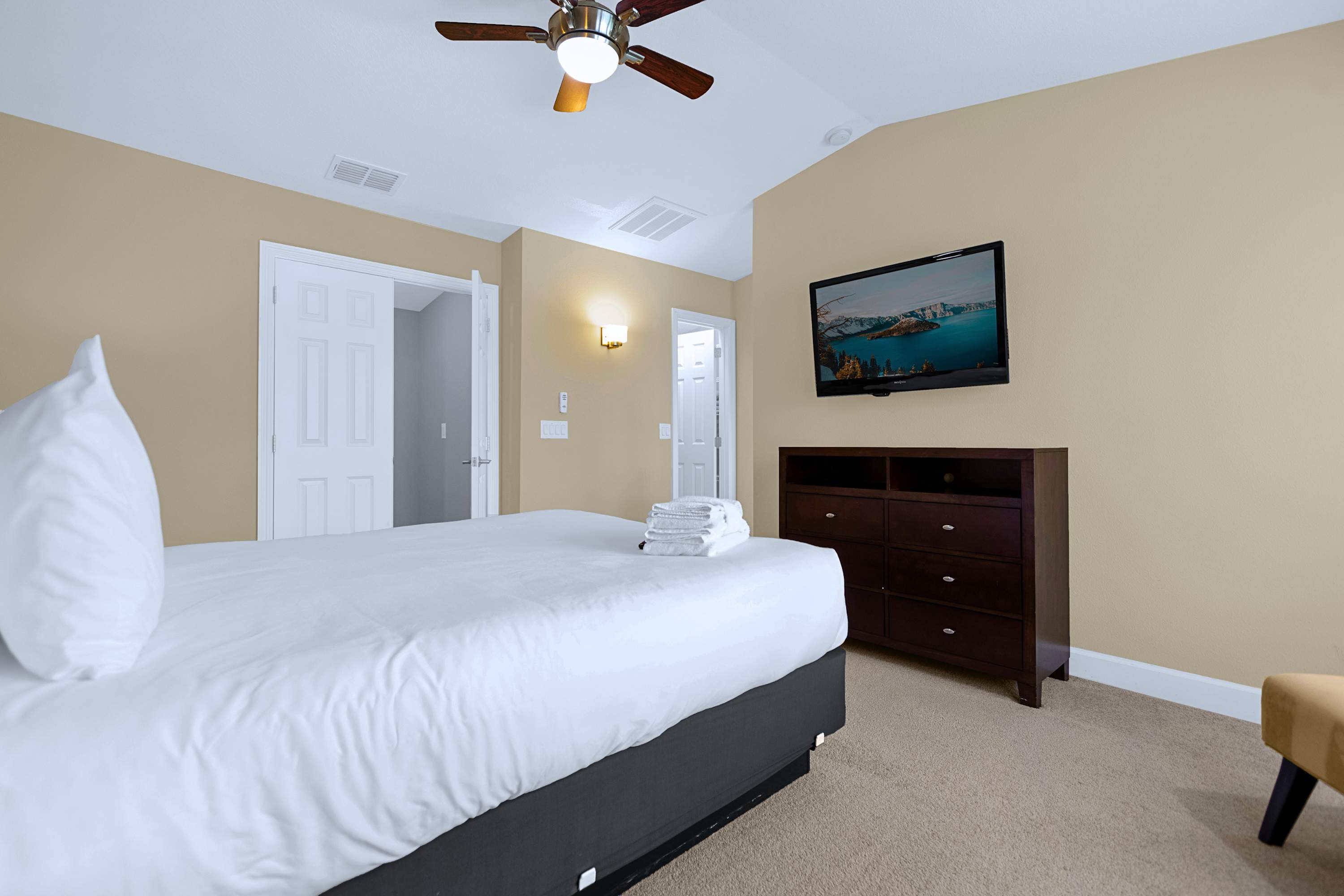 Comfortable guest suite featuring a wall-mounted TV for private entertainment