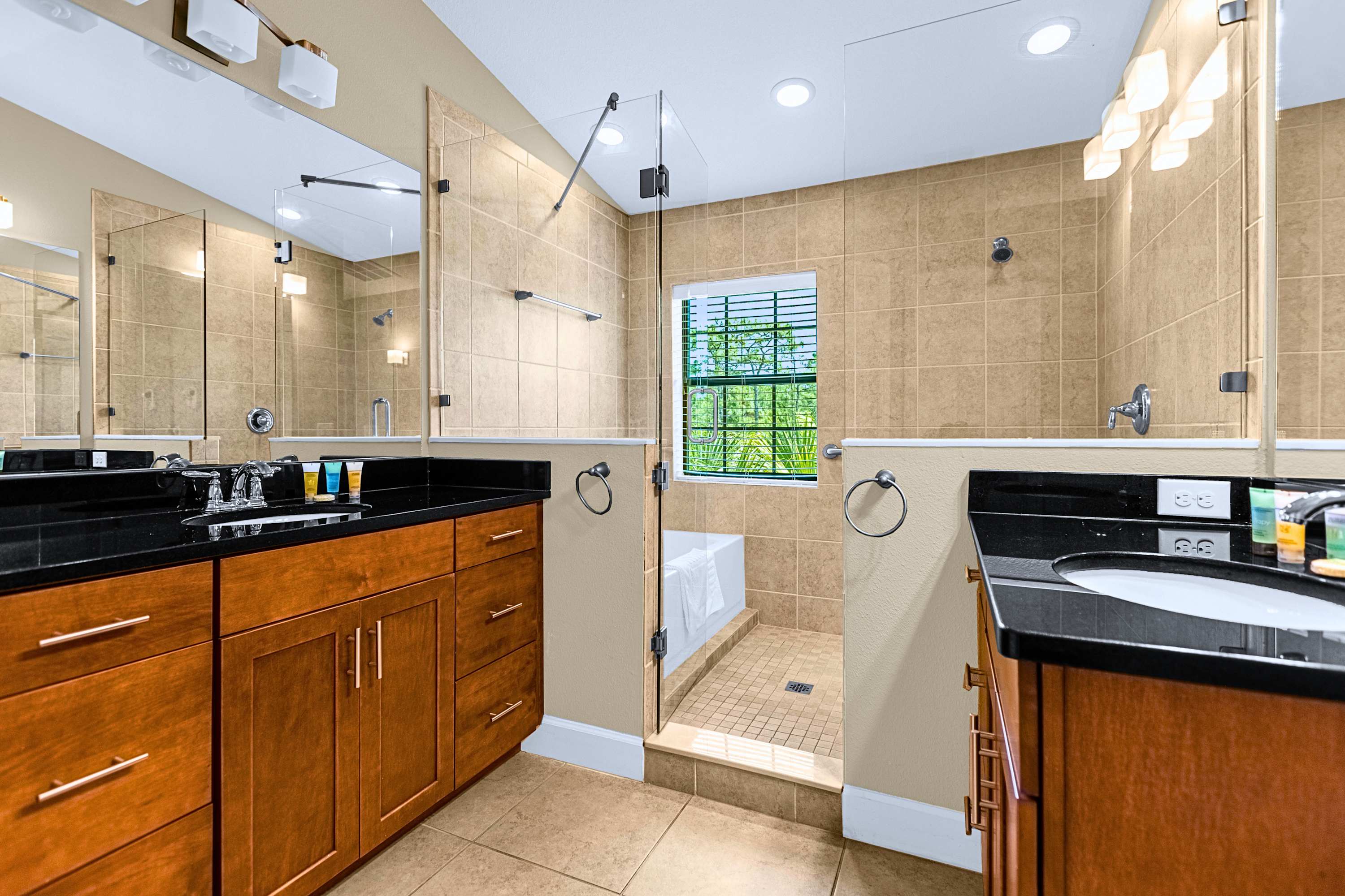 Spacious bathroom suite featuring a double vanity with ample lighting
