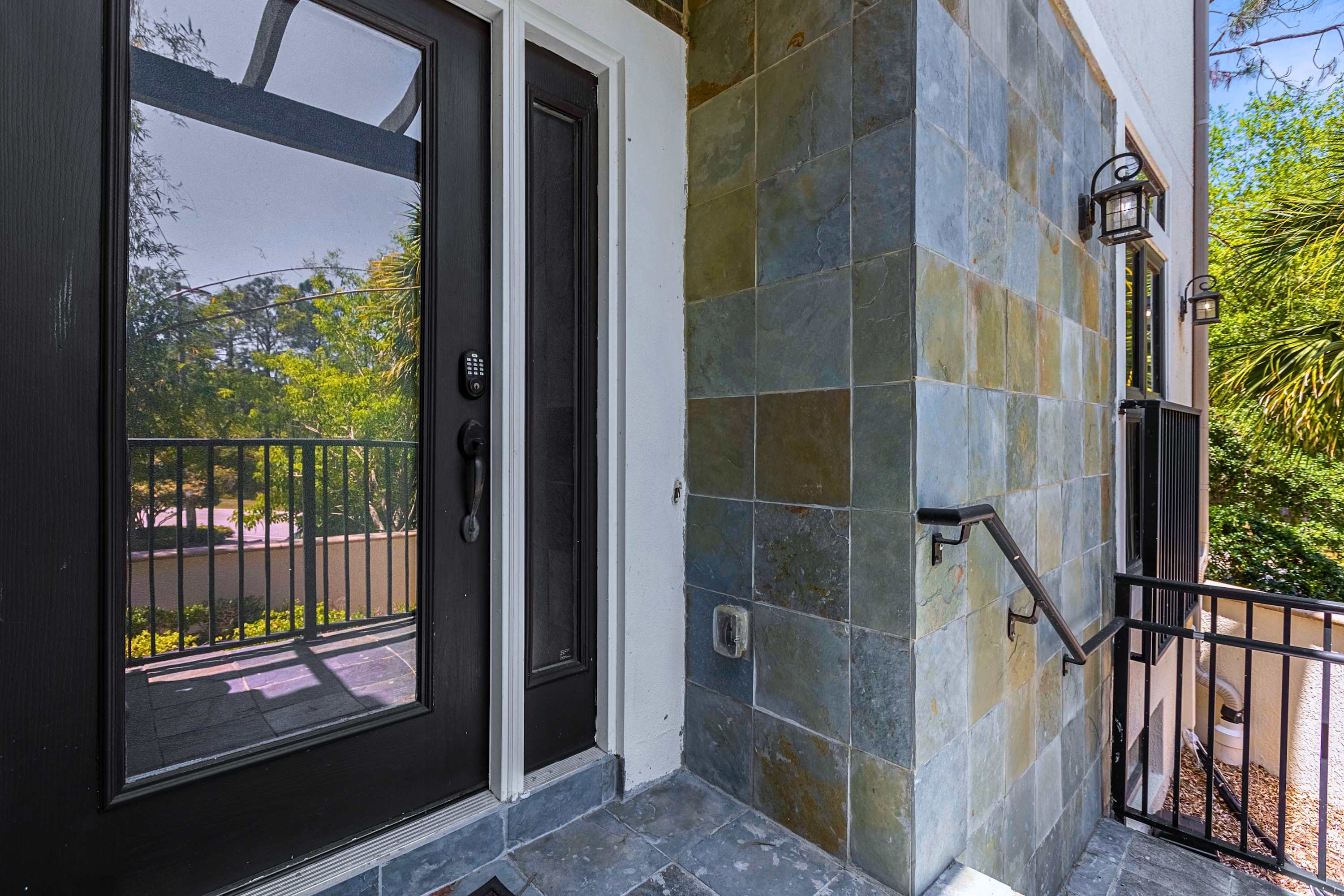 A welcoming front entry door framed by durable stonework accents