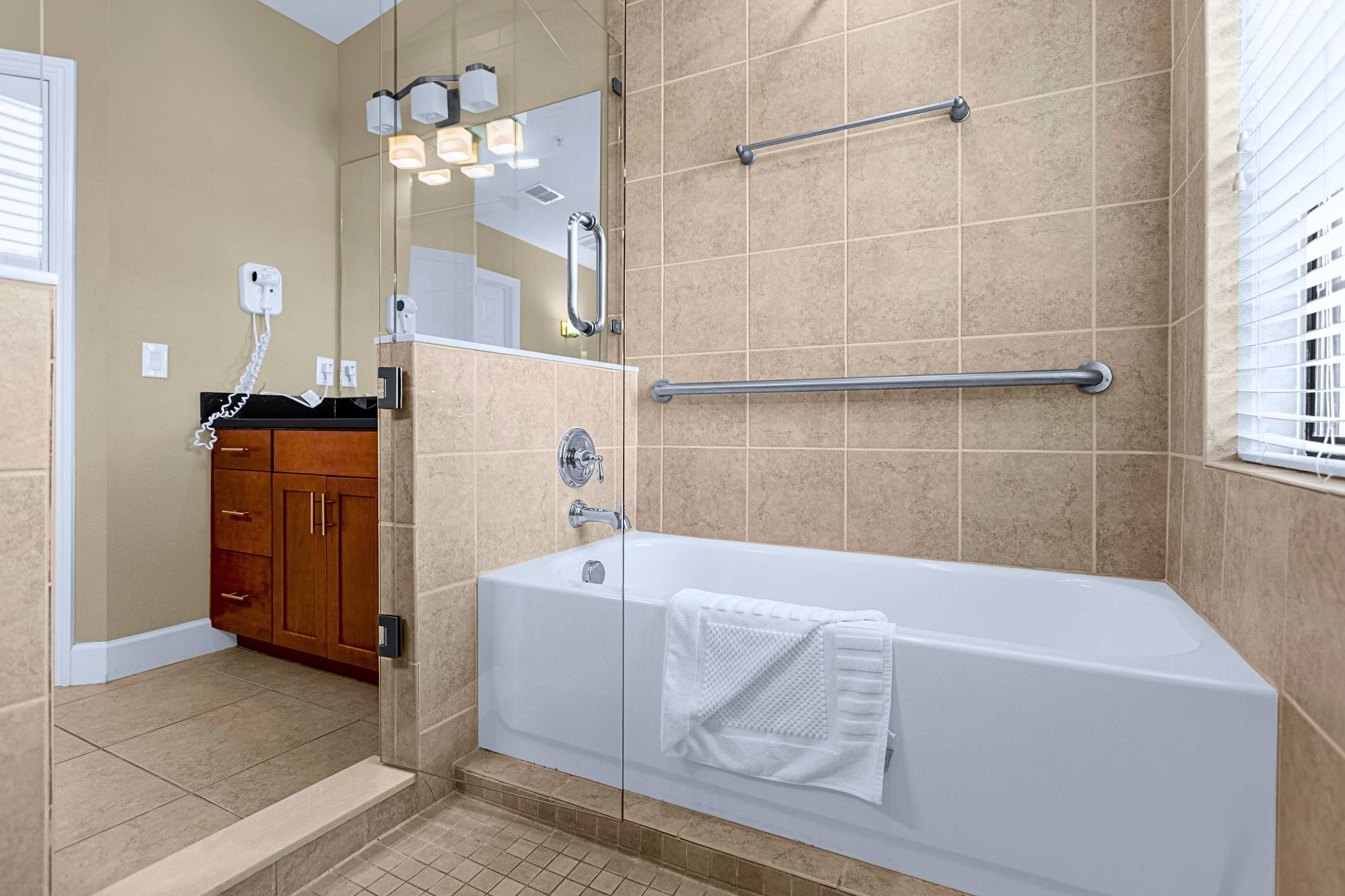 A luxurious bathroom layout complete with a deep soaking tub and tile finish